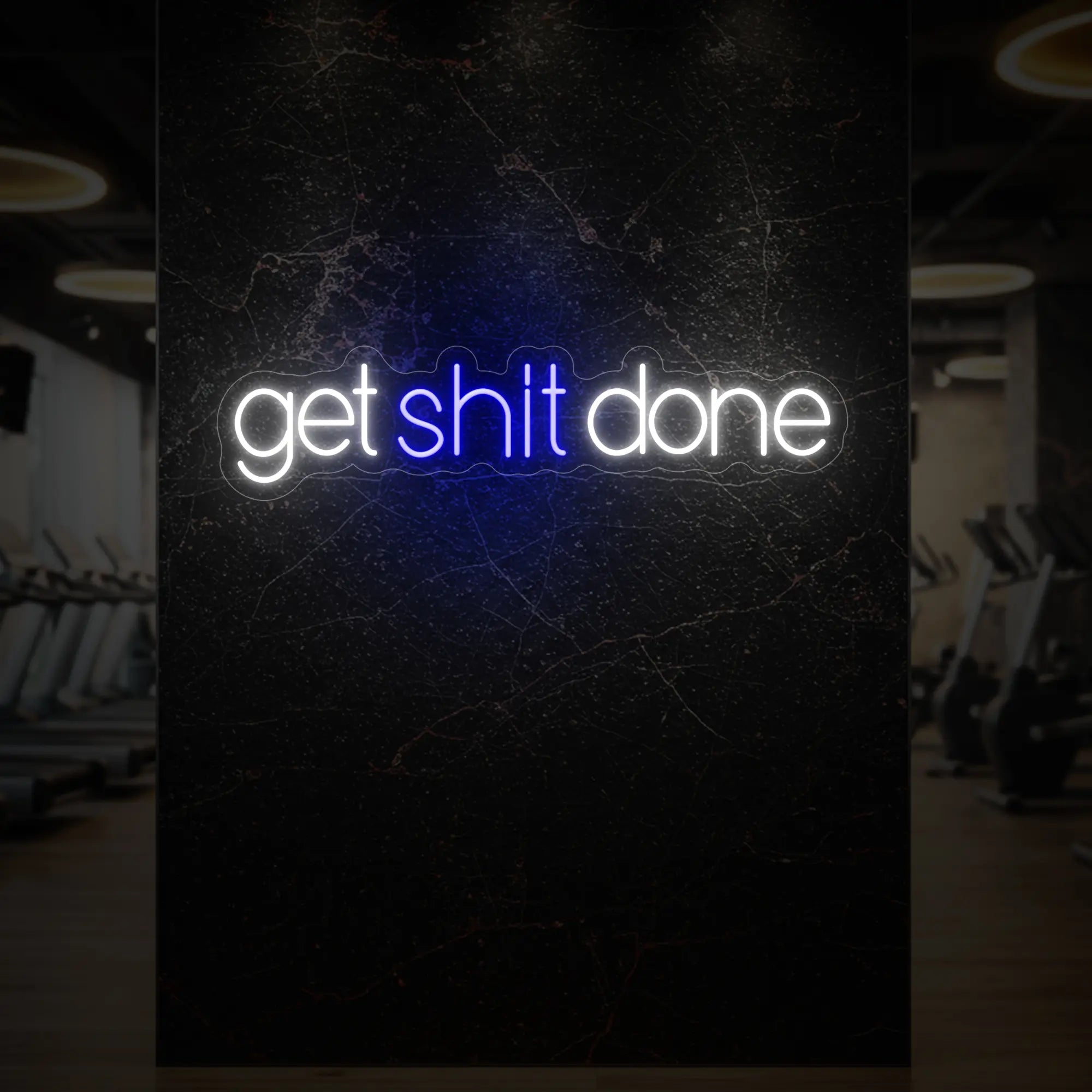 'Get Shit Done' neon sign glowing in deep blue against a styled interior wall.