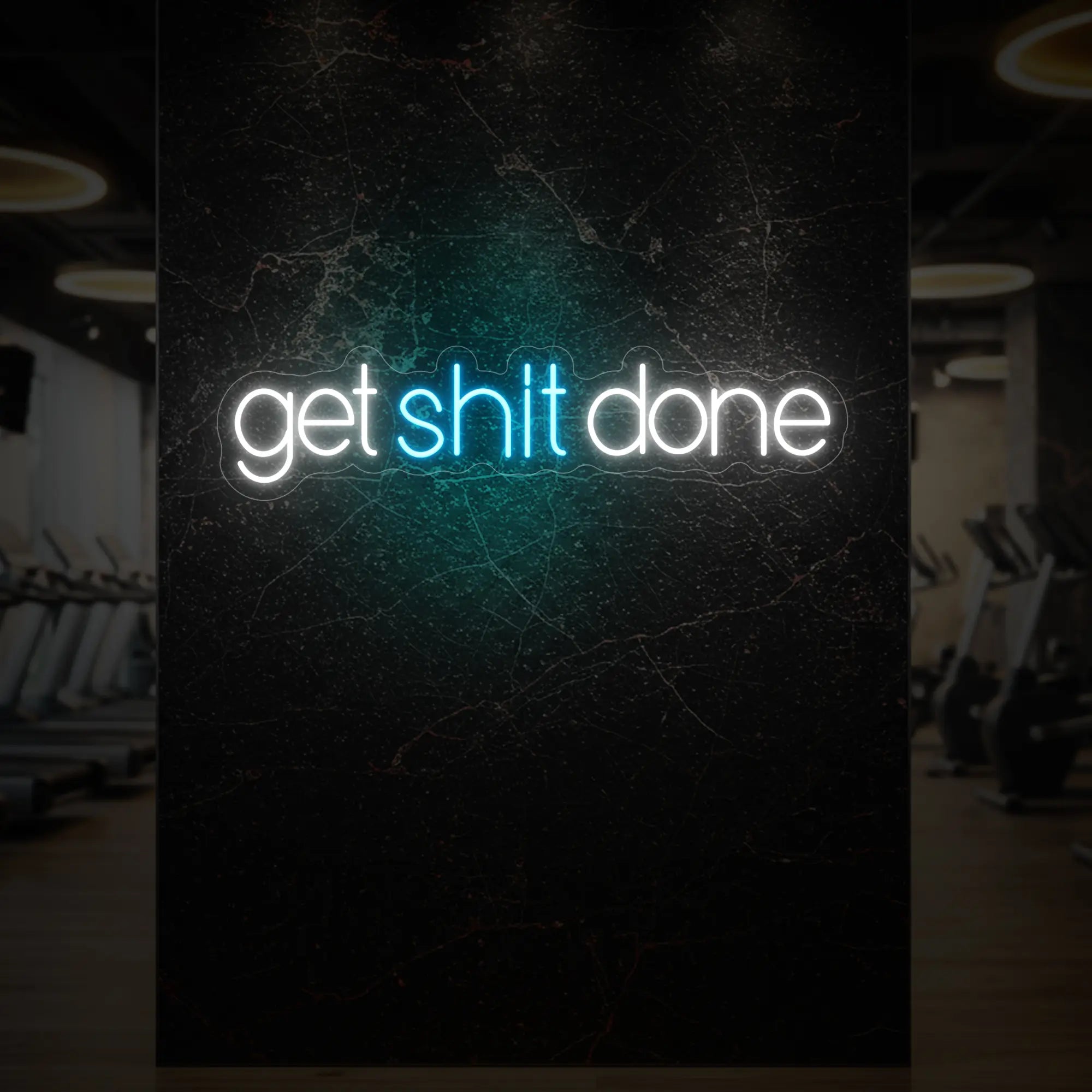 'Get Shit Done' neon sign glowing in ice blue against a styled interior wall.