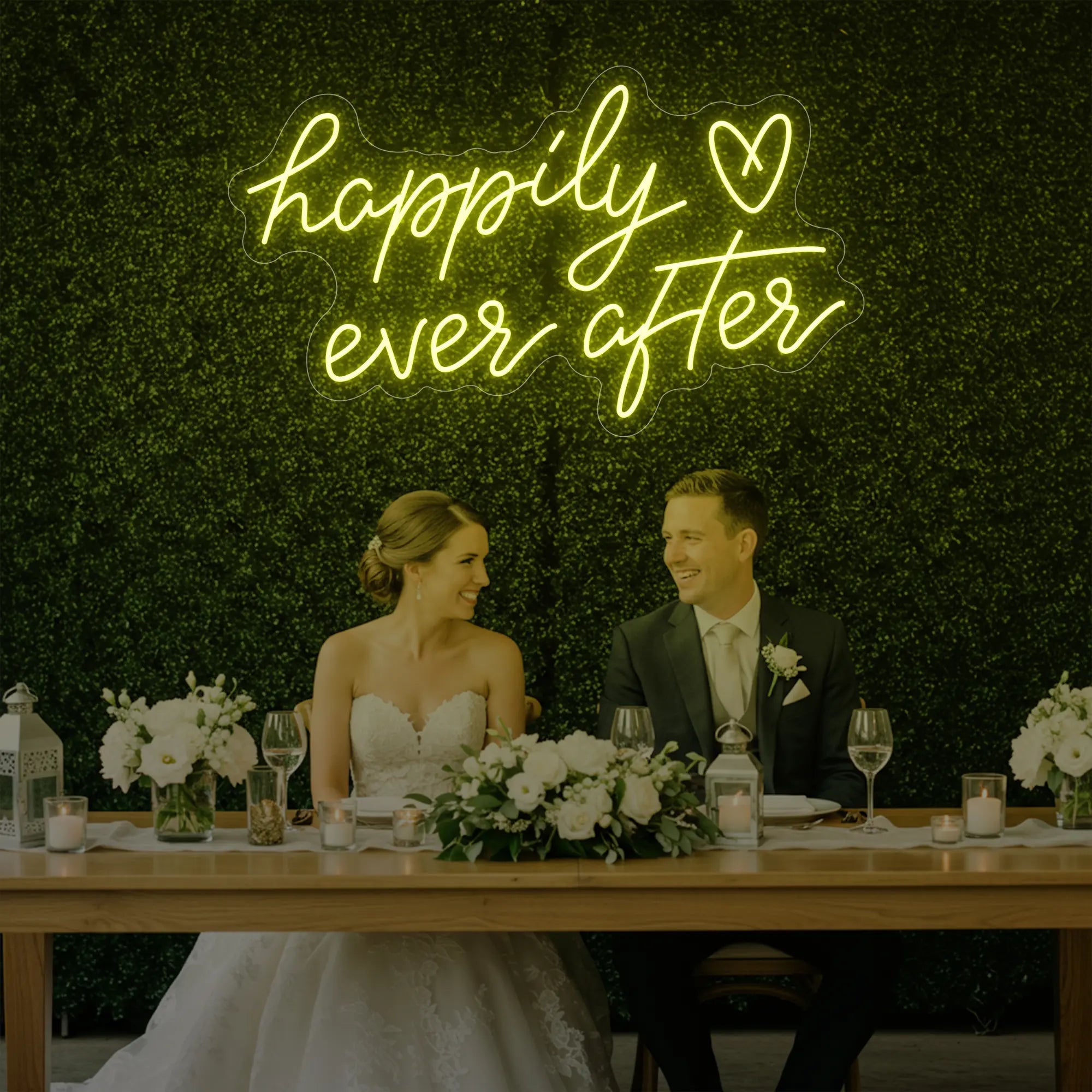 Photo of the 'Happily Ever After' neon sign glowing in lemon yellow against a styled interior wall.