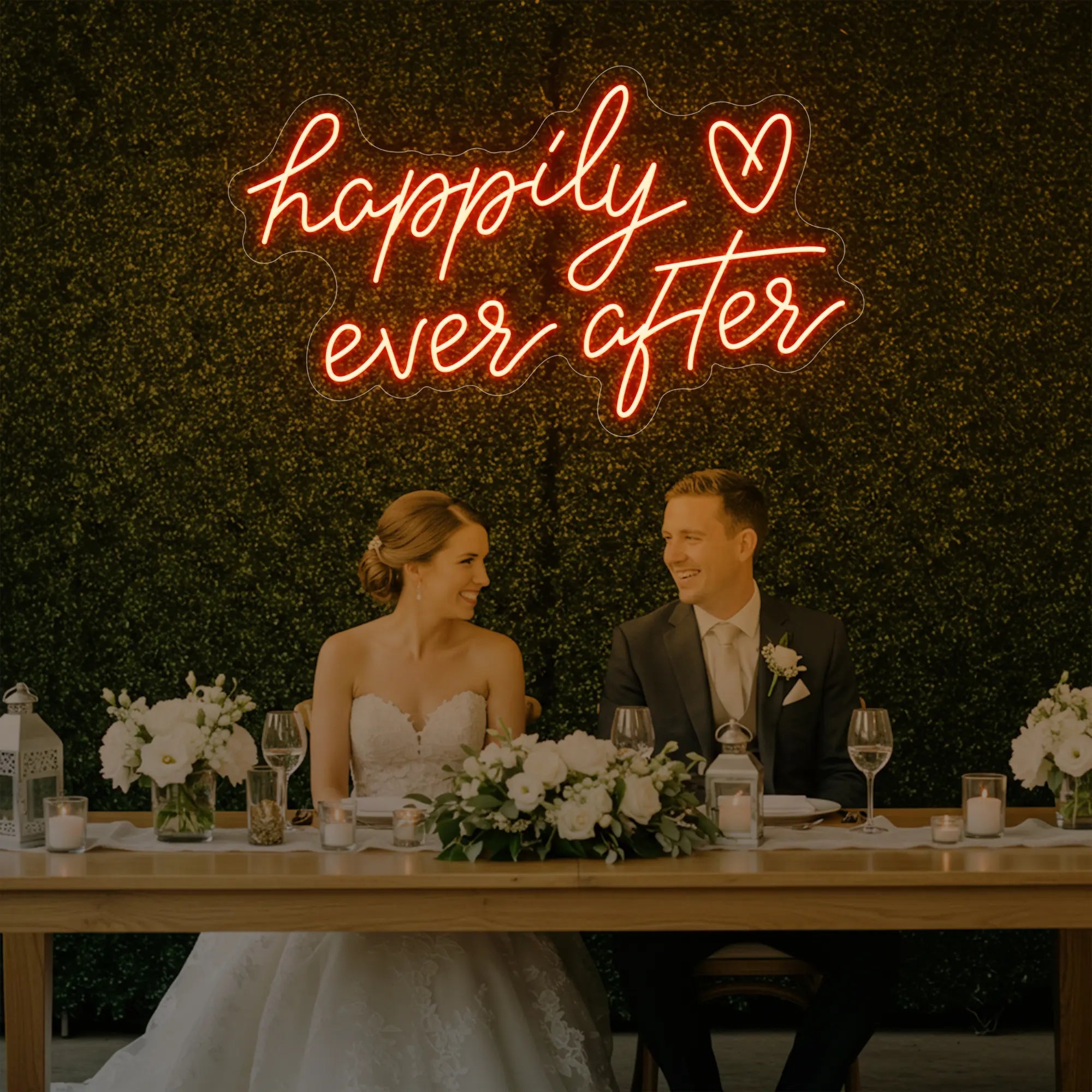 Photo of the 'Happily Ever After' neon sign glowing in golden yellow against a styled interior wall.