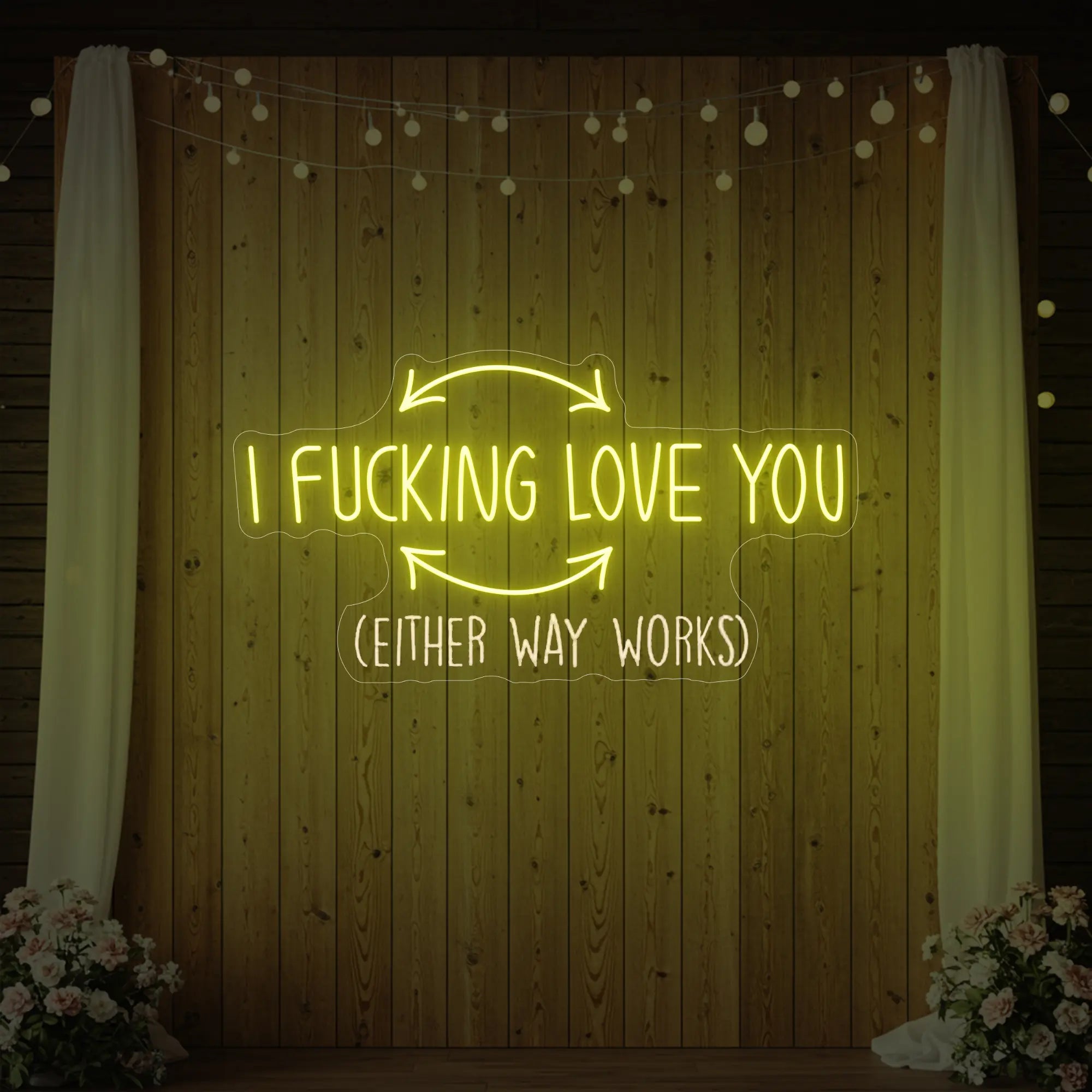 Photo of the 'I F'ing Love You' neon sign glowing in lemon yellow against a styled interior wall.