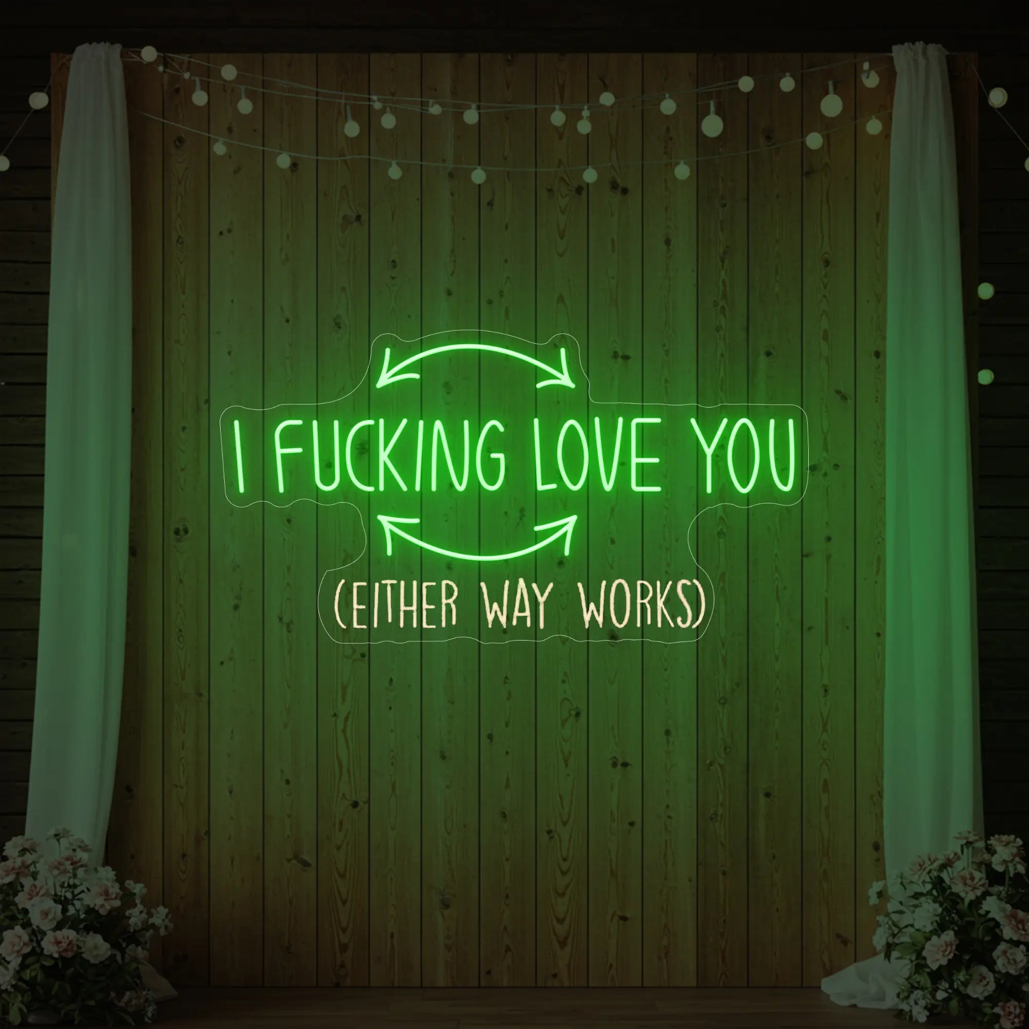 Photo of the 'I F'ing Love You' neon sign glowing in green against a styled interior wall.