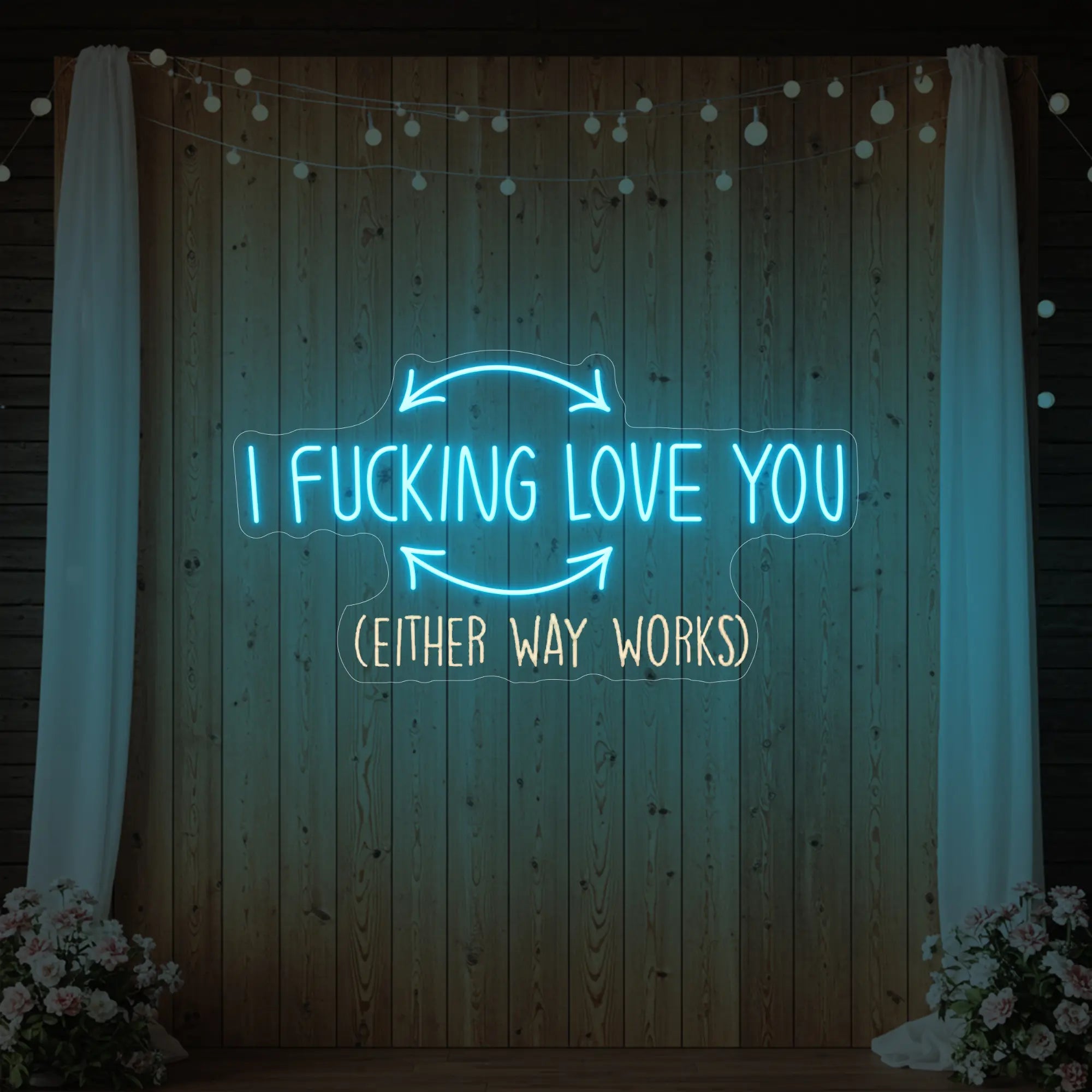 Photo of the 'I F'ing Love You' neon sign glowing in ice blue against a styled interior wall.
