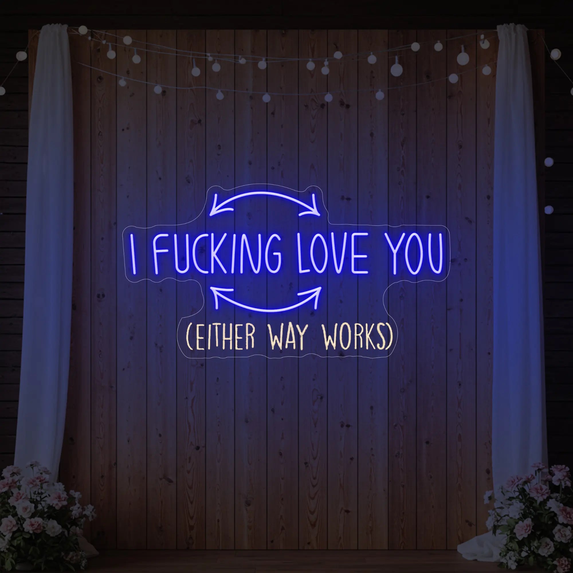 Photo of the 'I F'ing Love You' neon sign glowing in deep blue against a styled interior wall.