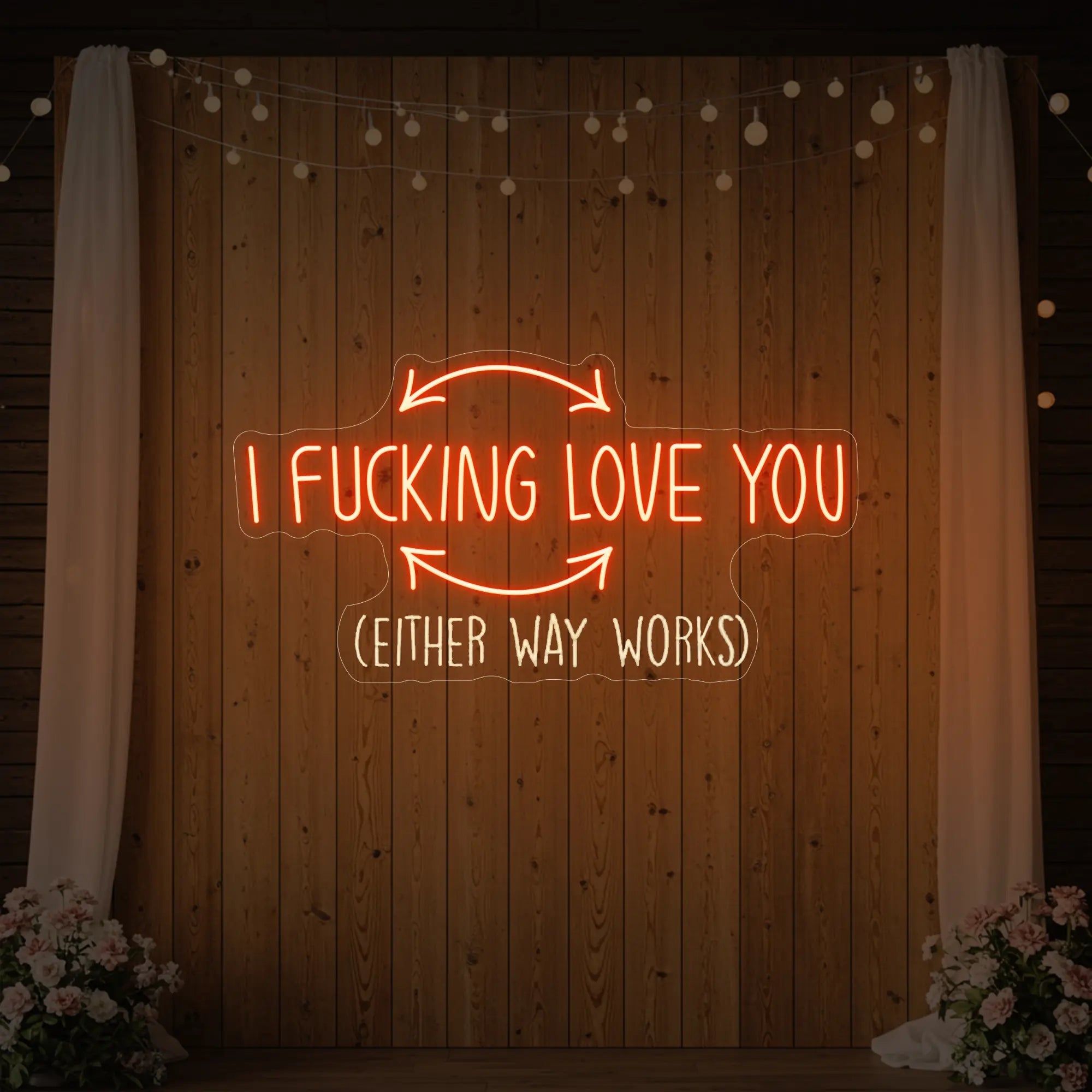 Photo of the 'I F'ing Love You' neon sign glowing in golden yellow against a styled interior wall.