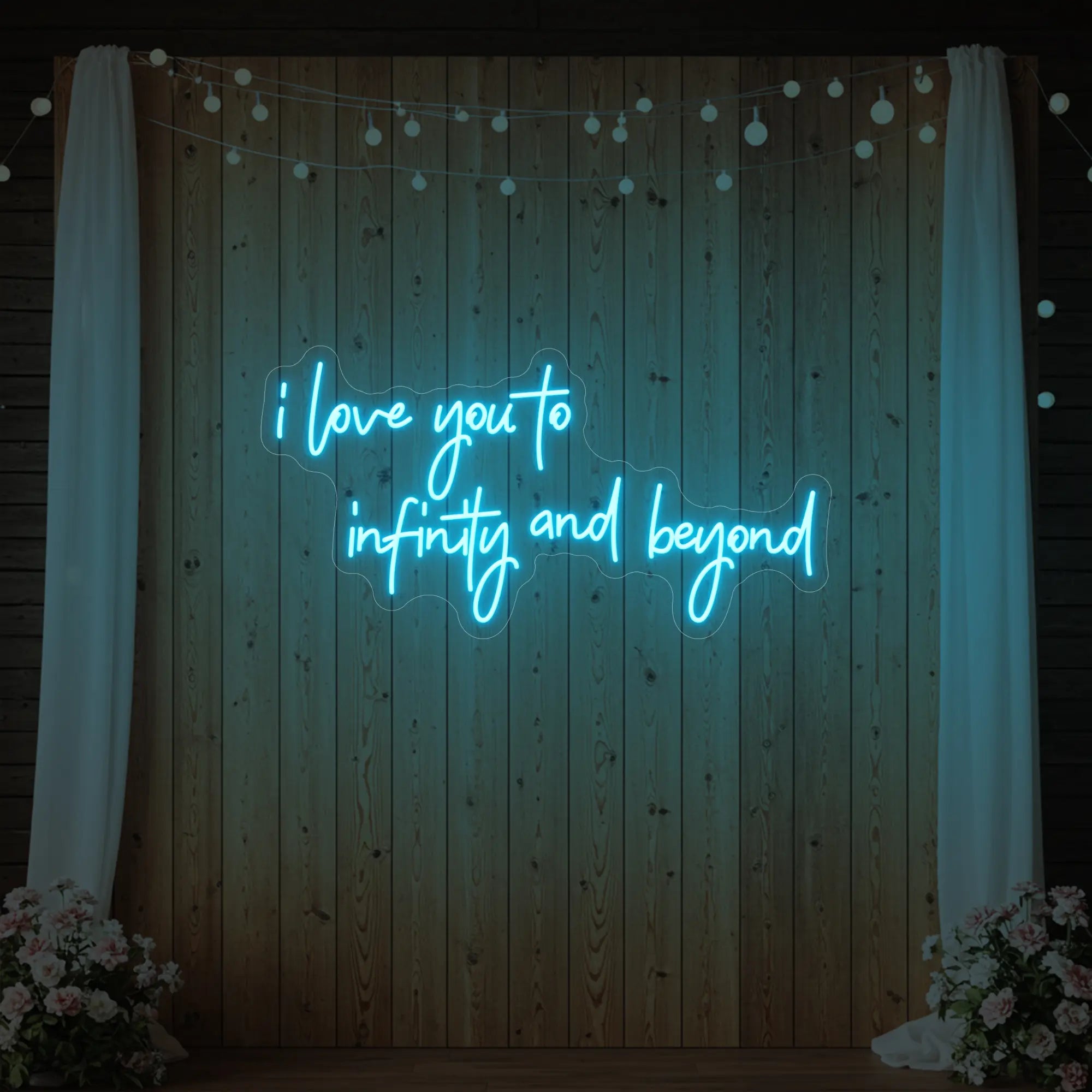 Photo of the 'I Love You to Infinity and Beyond' neon sign glowing in ice blue against a styled interior wall.
