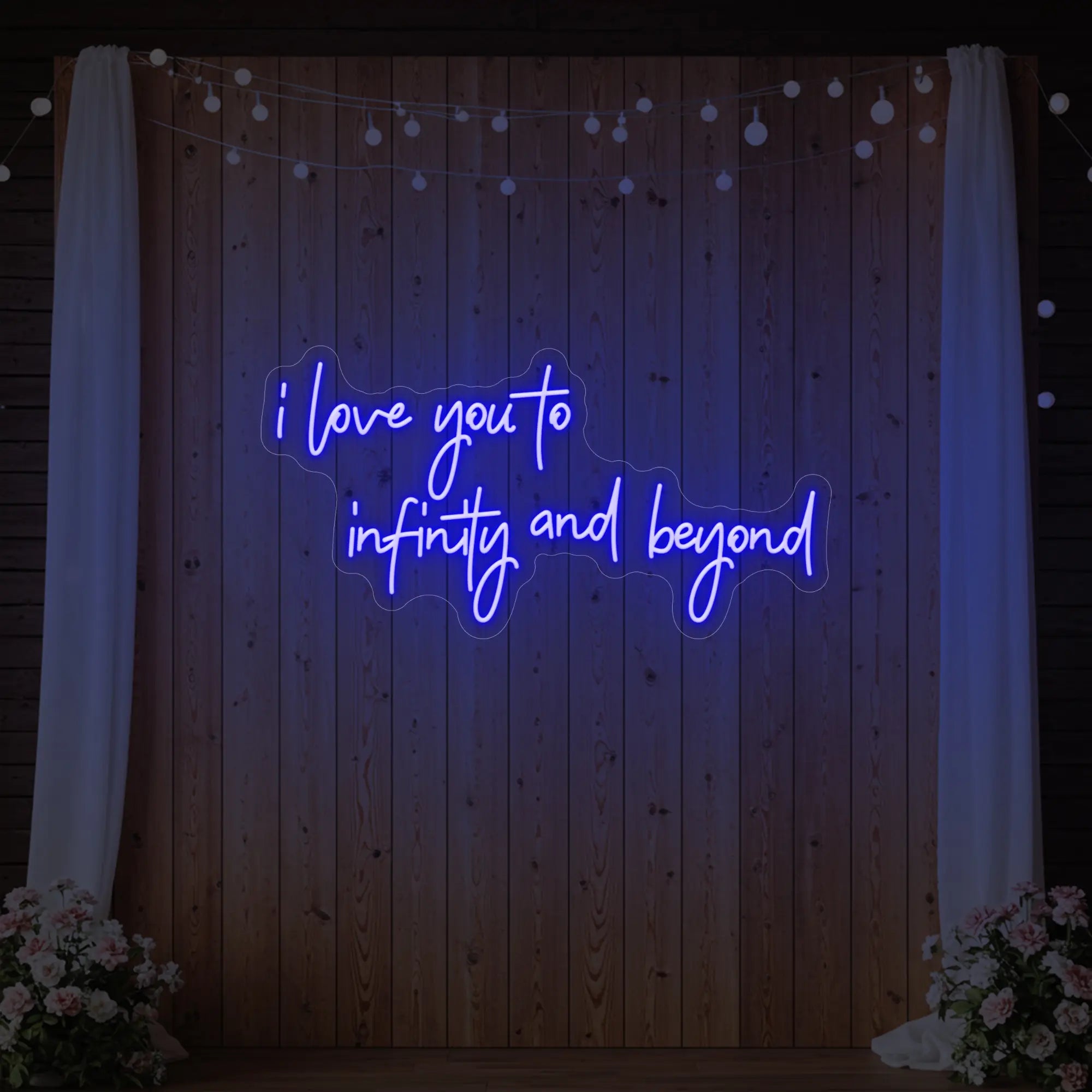 Photo of the 'I Love You to Infinity and Beyond' neon sign glowing in deep blue against a styled interior wall.