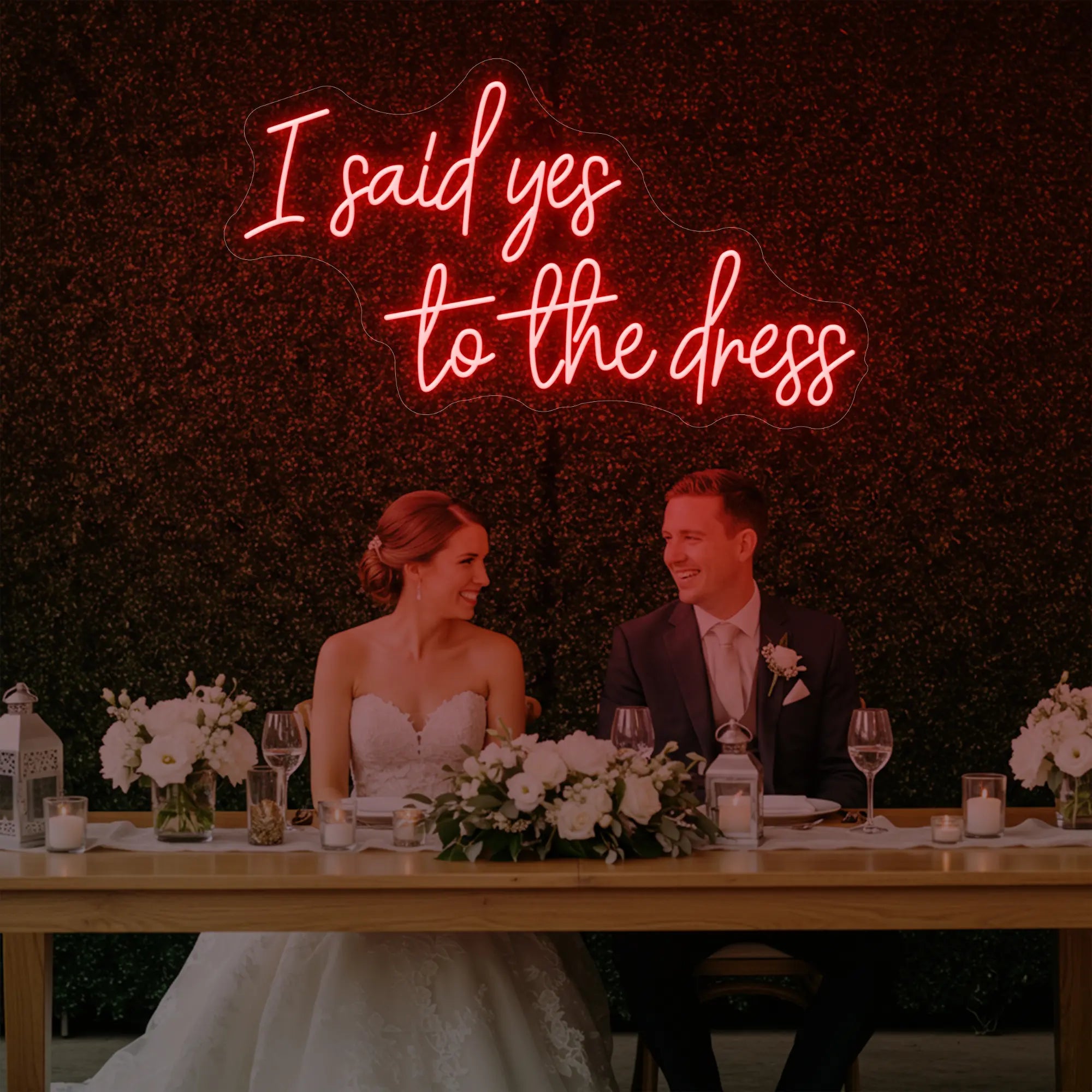 Photo of the 'I Said Yes To The Dress' neon sign glowing in red against a styled interior wall.