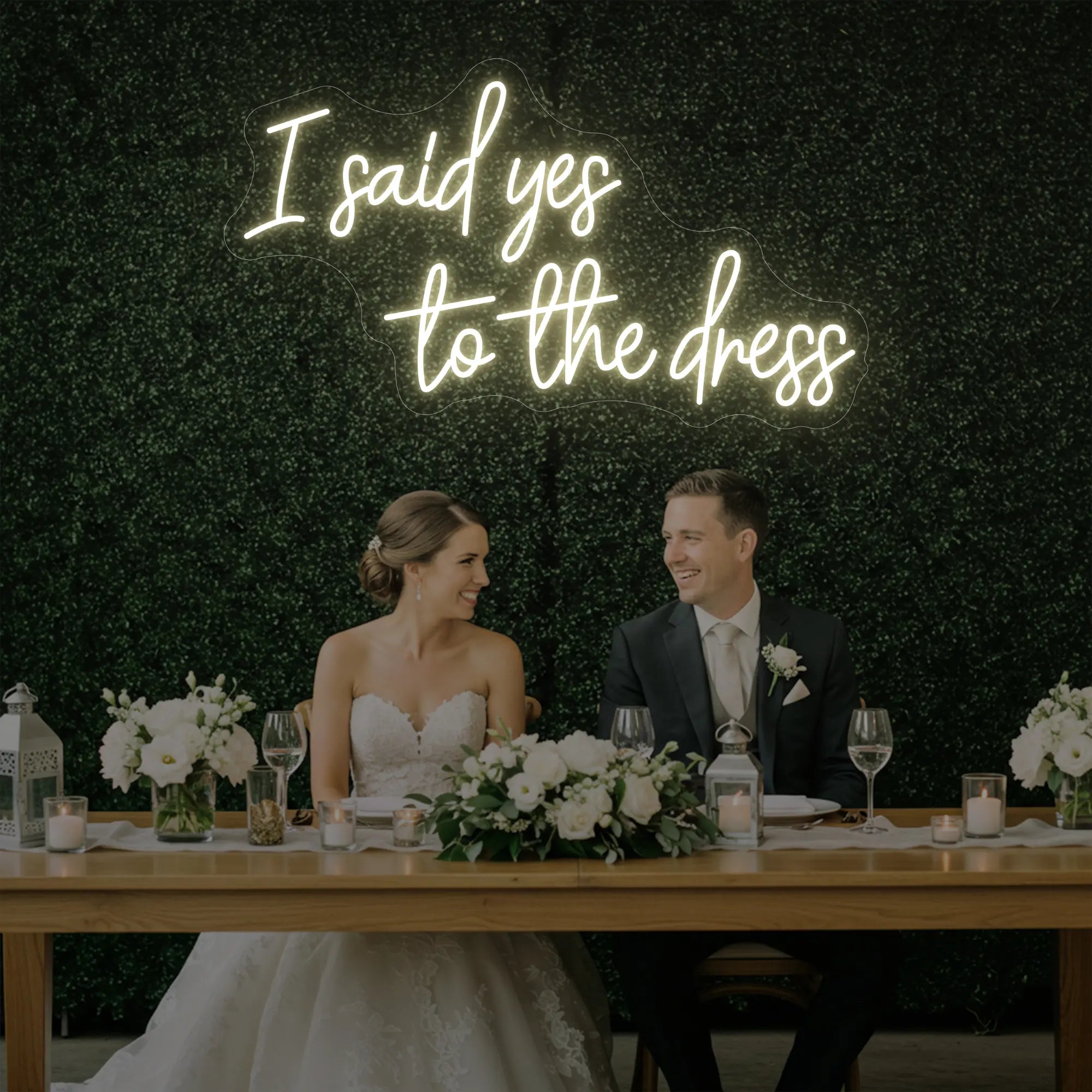 Photo of the 'I Said Yes To The Dress' neon sign glowing in warm white against a styled interior wall.