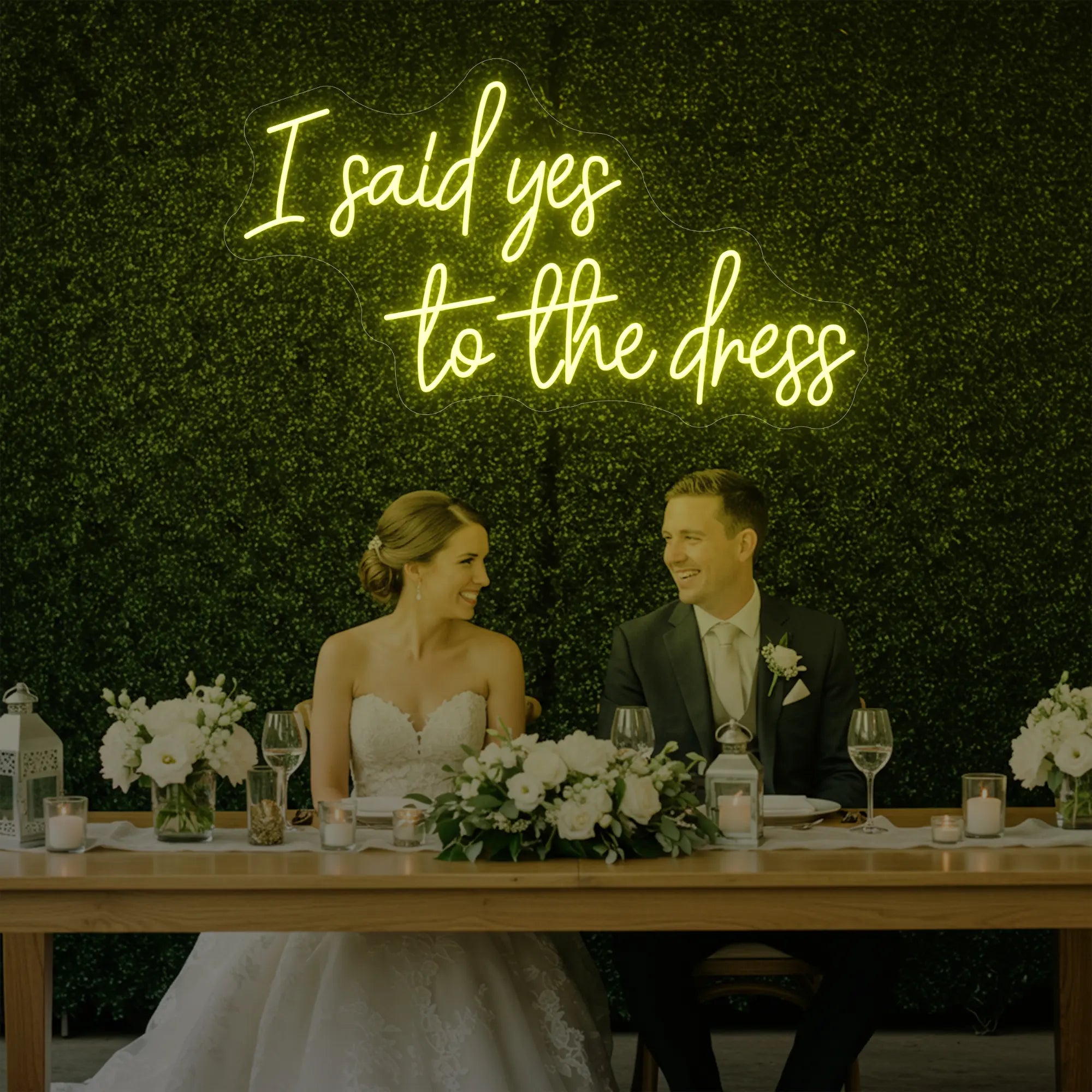Photo of the 'I Said Yes To The Dress' neon sign glowing in lemon yellow against a styled interior wall.