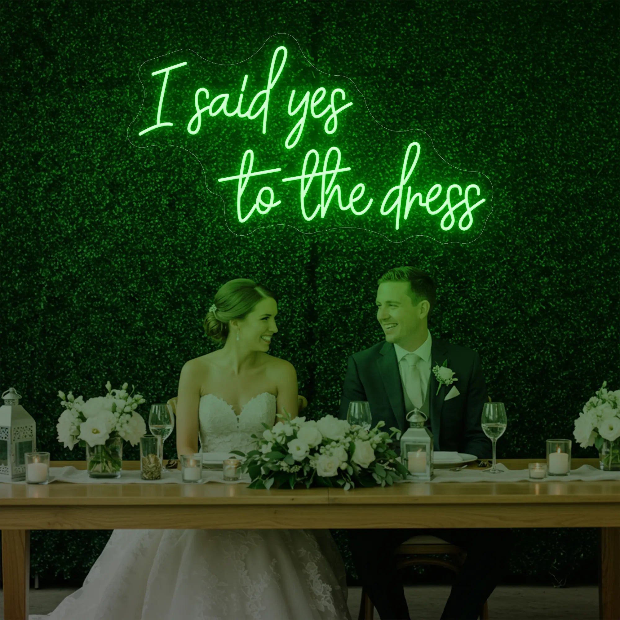 Photo of the 'I Said Yes To The Dress' neon sign glowing in green against a styled interior wall.