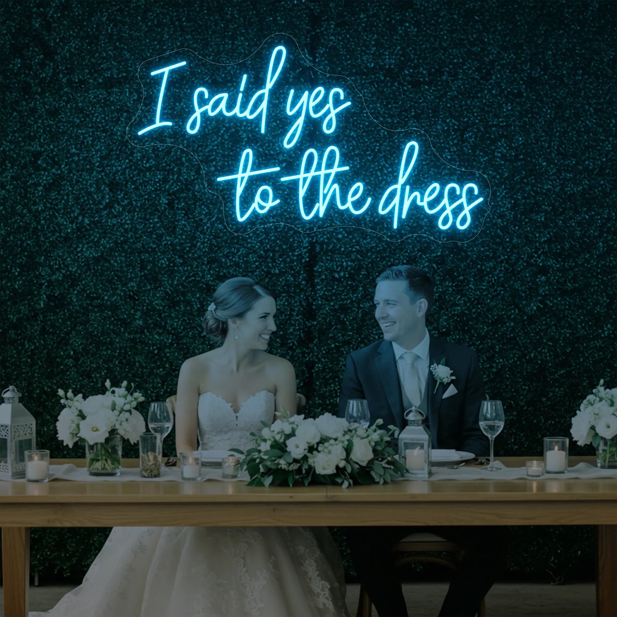 Photo of the 'I Said Yes To The Dress' neon sign glowing in ice blue against a styled interior wall.