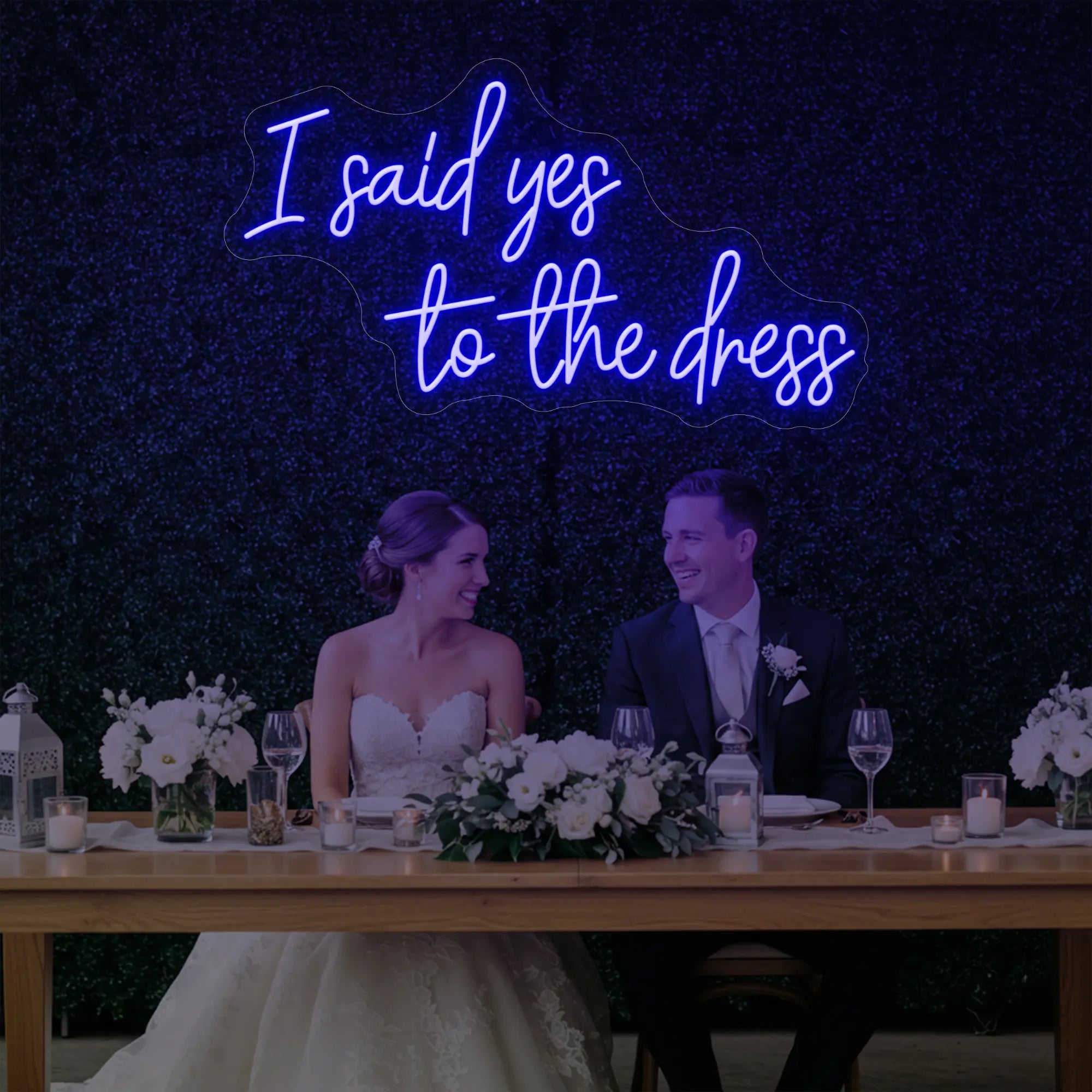 Photo of the 'I Said Yes To The Dress' neon sign glowing in deep blue against a styled interior wall.