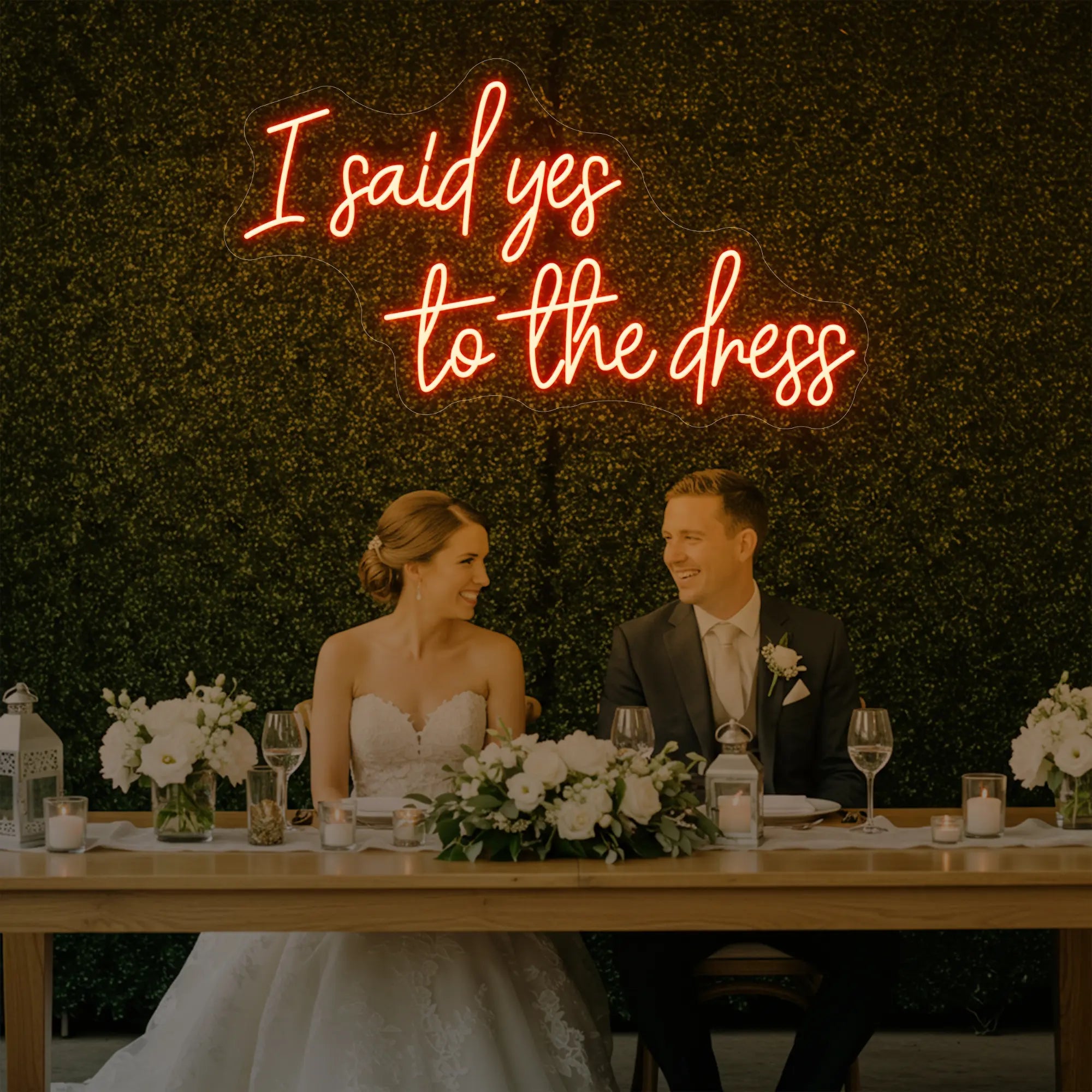 Photo of the 'I Said Yes To The Dress' neon sign glowing in golden yellow against a styled interior wall.