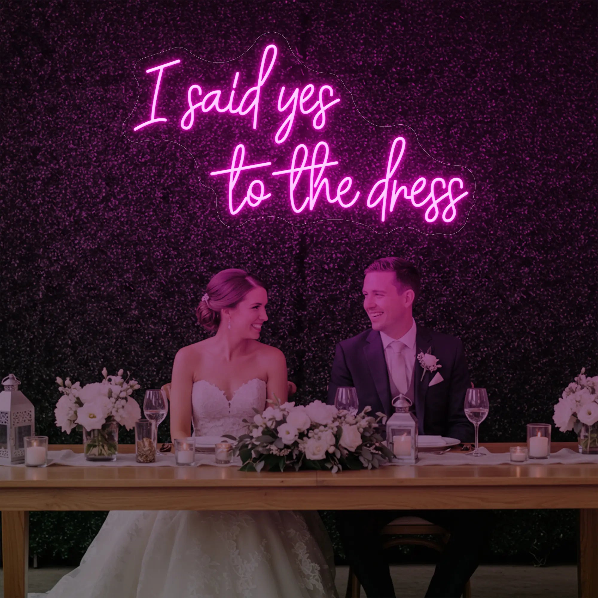 Photo of the 'I Said Yes To The Dress' neon sign glowing in light pink against a styled interior wall.