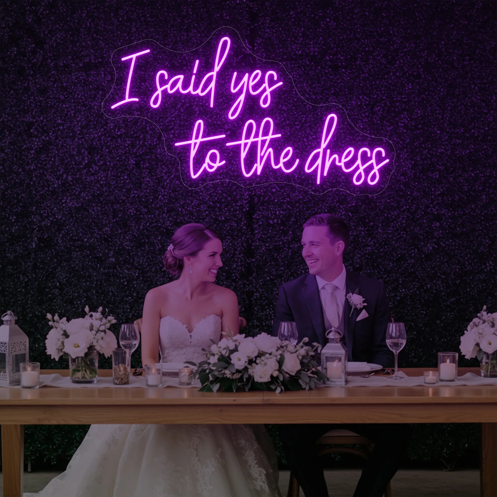 Photo of the 'I Said Yes To The Dress' neon sign glowing in deep pink against a styled interior wall.