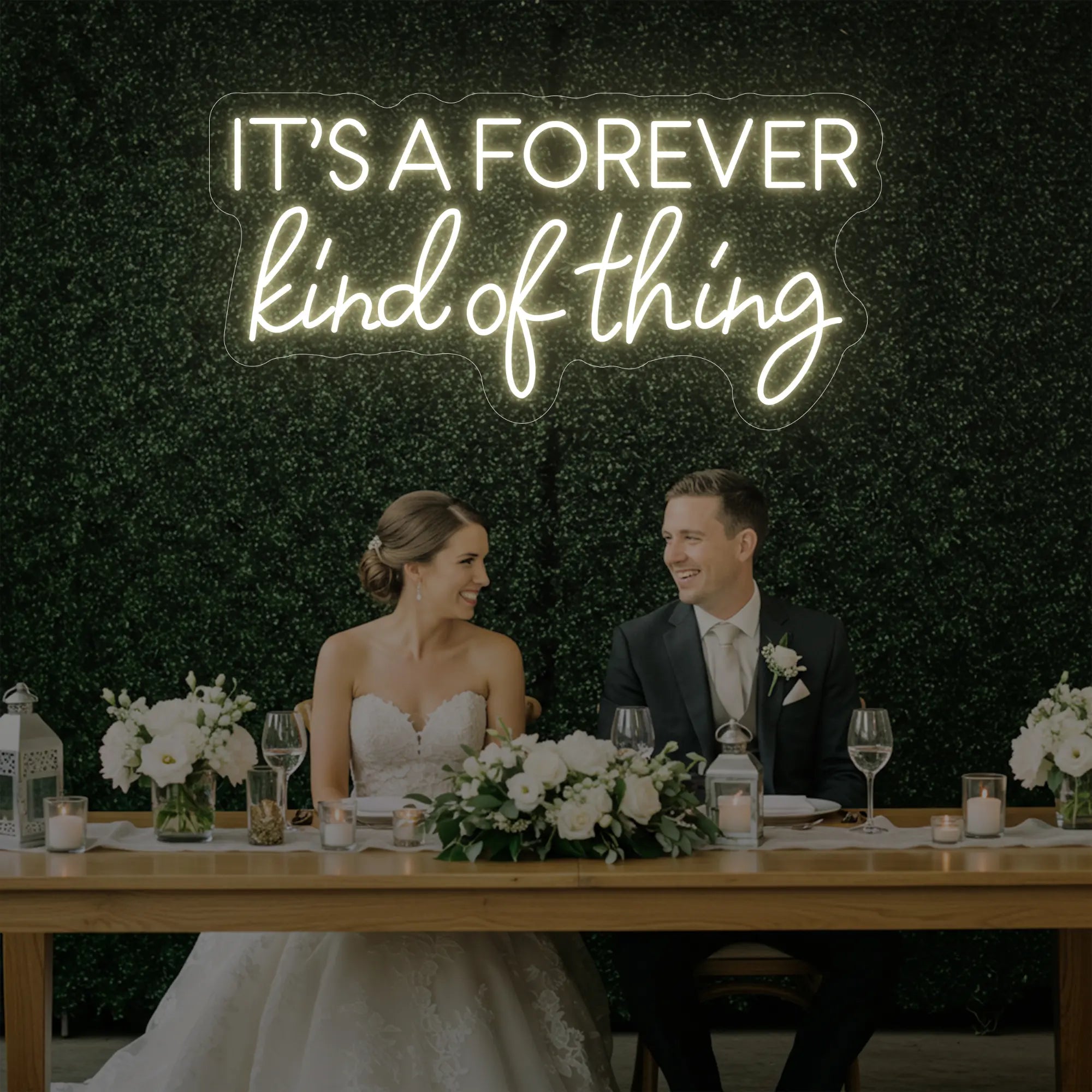 Photo of the 'It’s a Forever Kind of Thing' neon sign glowing in warm white against a styled interior wall.
