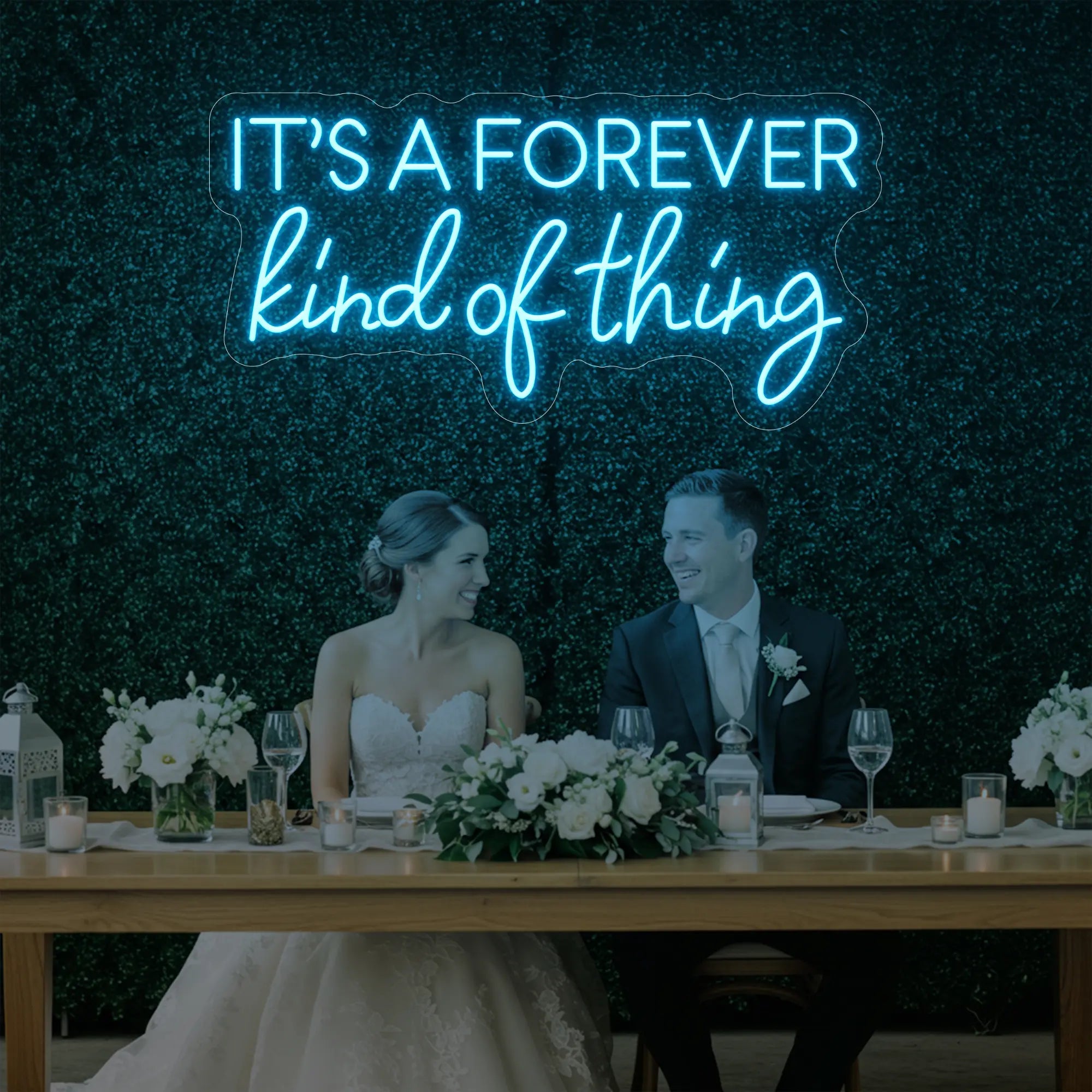 Photo of the 'It’s a Forever Kind of Thing' neon sign glowing in ice blue against a styled interior wall.