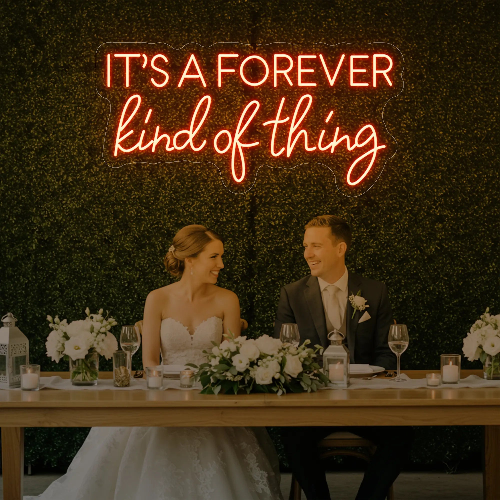 Photo of the 'It’s a Forever Kind of Thing' neon sign glowing in golden yellow against a styled interior wall.