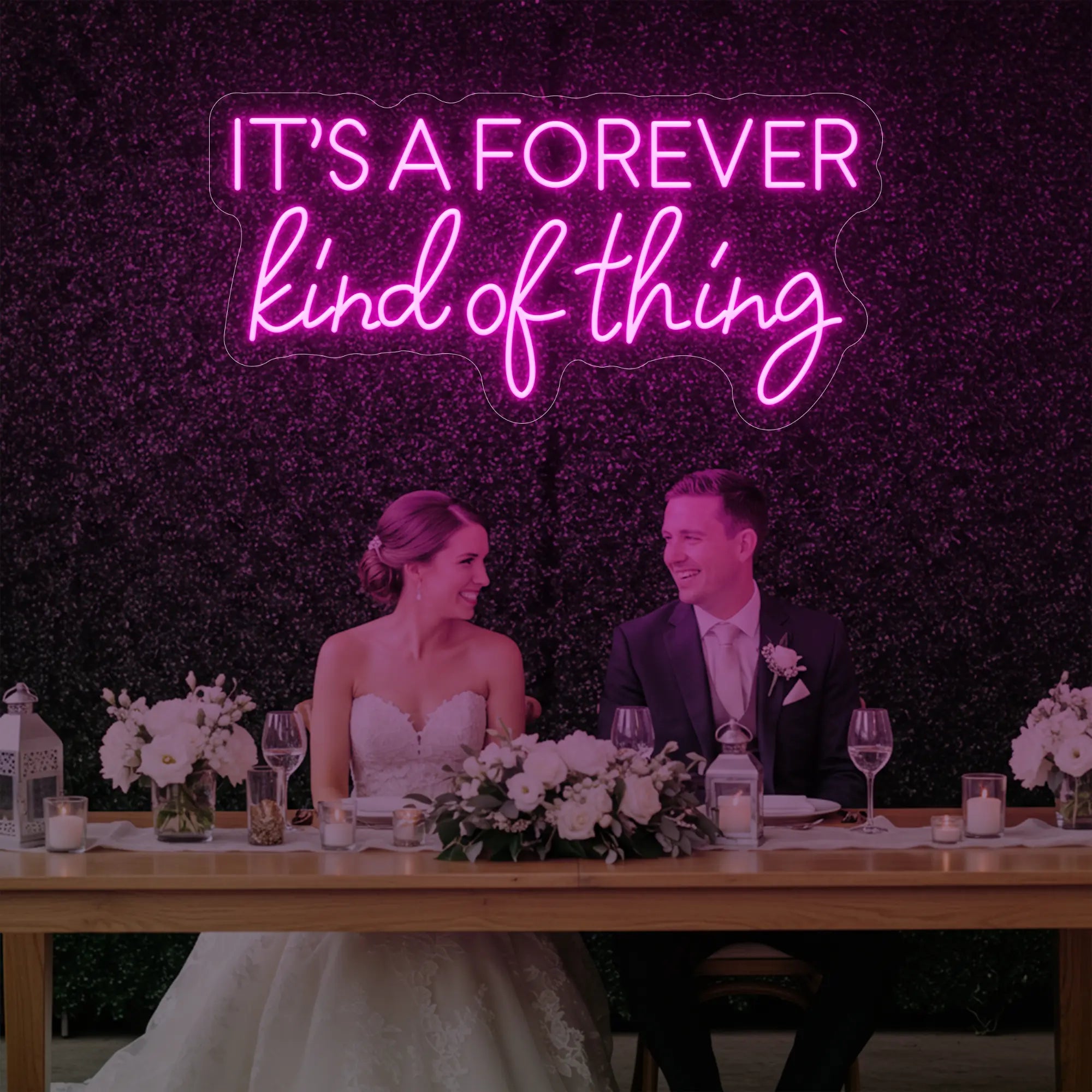 Photo of the 'It’s a Forever Kind of Thing' neon sign glowing in light pink against a styled interior wall.