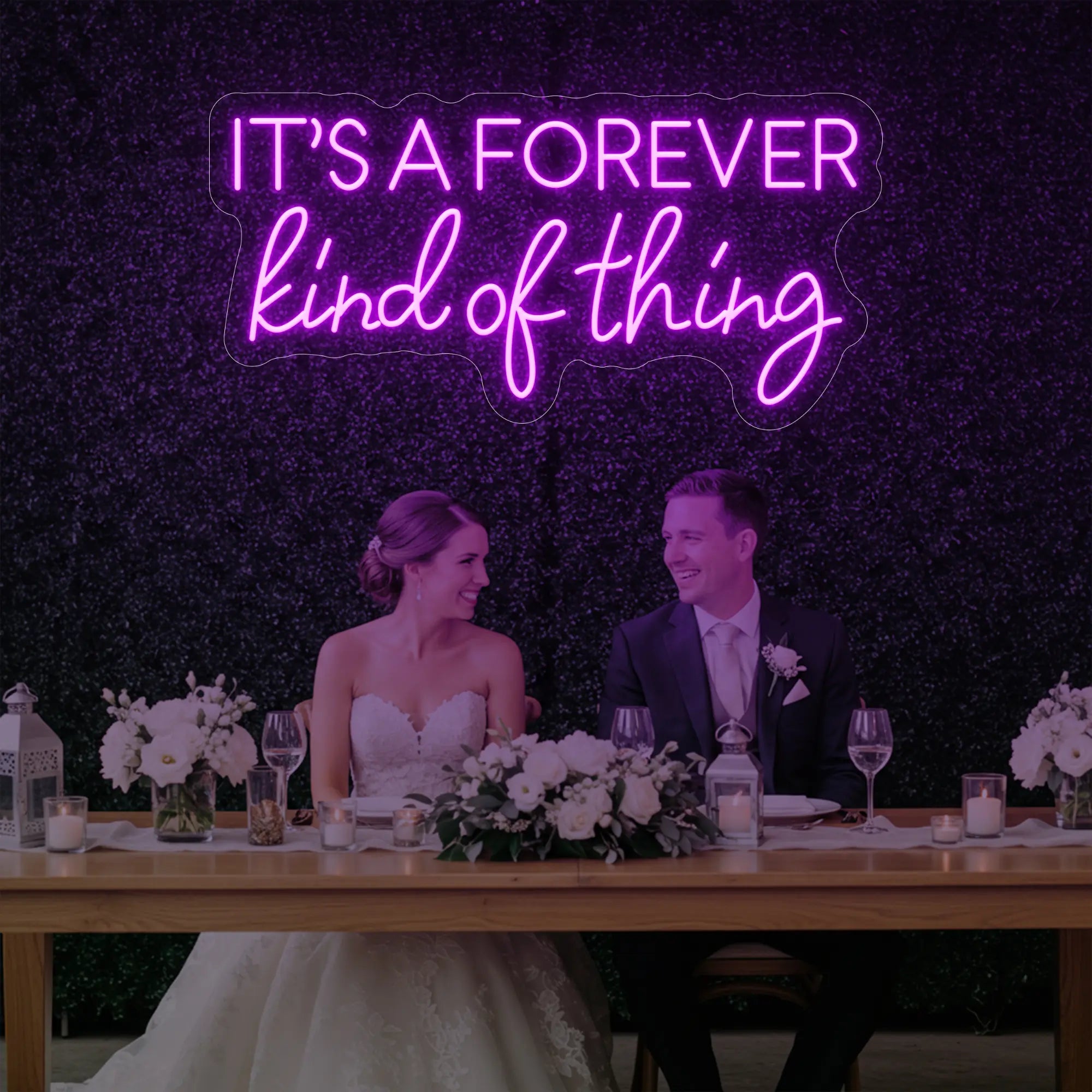 Photo of the 'It’s a Forever Kind of Thing' neon sign glowing in deep pink against a styled interior wall.