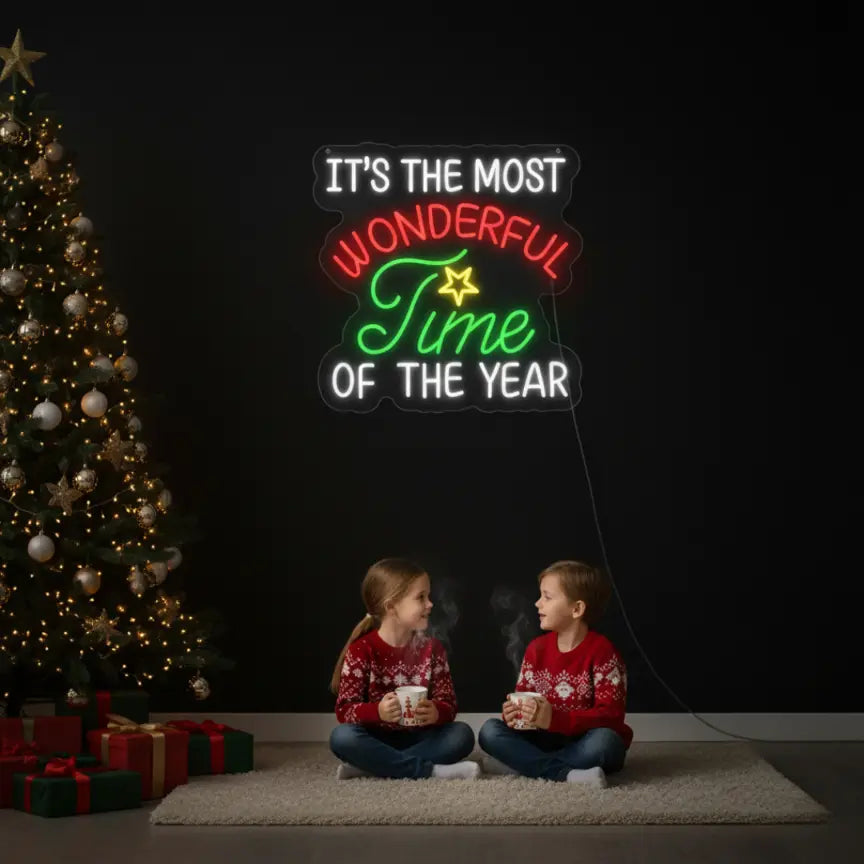 Photo of the 'It’s the Most Wonderful Time of the Year V2' neon sign glowing in multicolor against a styled interior wall.