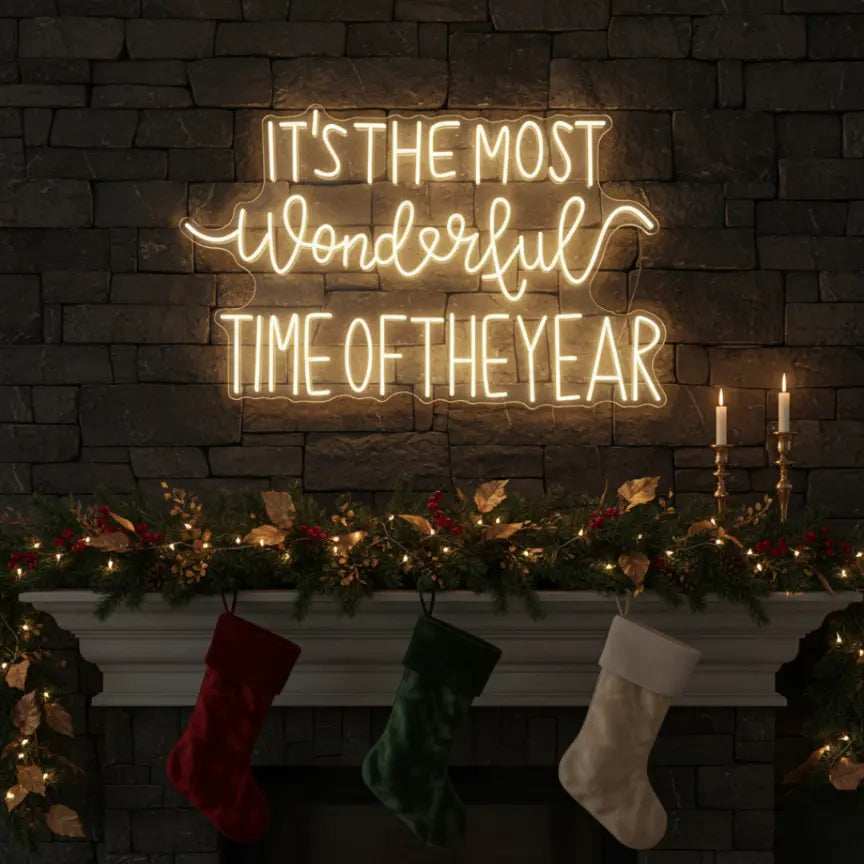 Photo of the 'It’s the Most Wonderful Time of the Year' neon sign glowing in warm white against a styled interior wall.