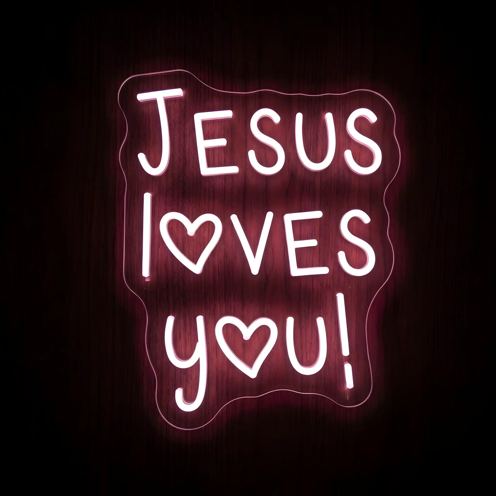 Jesus Loves You LED neon sign featuring pink illuminated lettering with heart-shaped accents on a precision-cut clear acrylic backing for Christian wall decor.