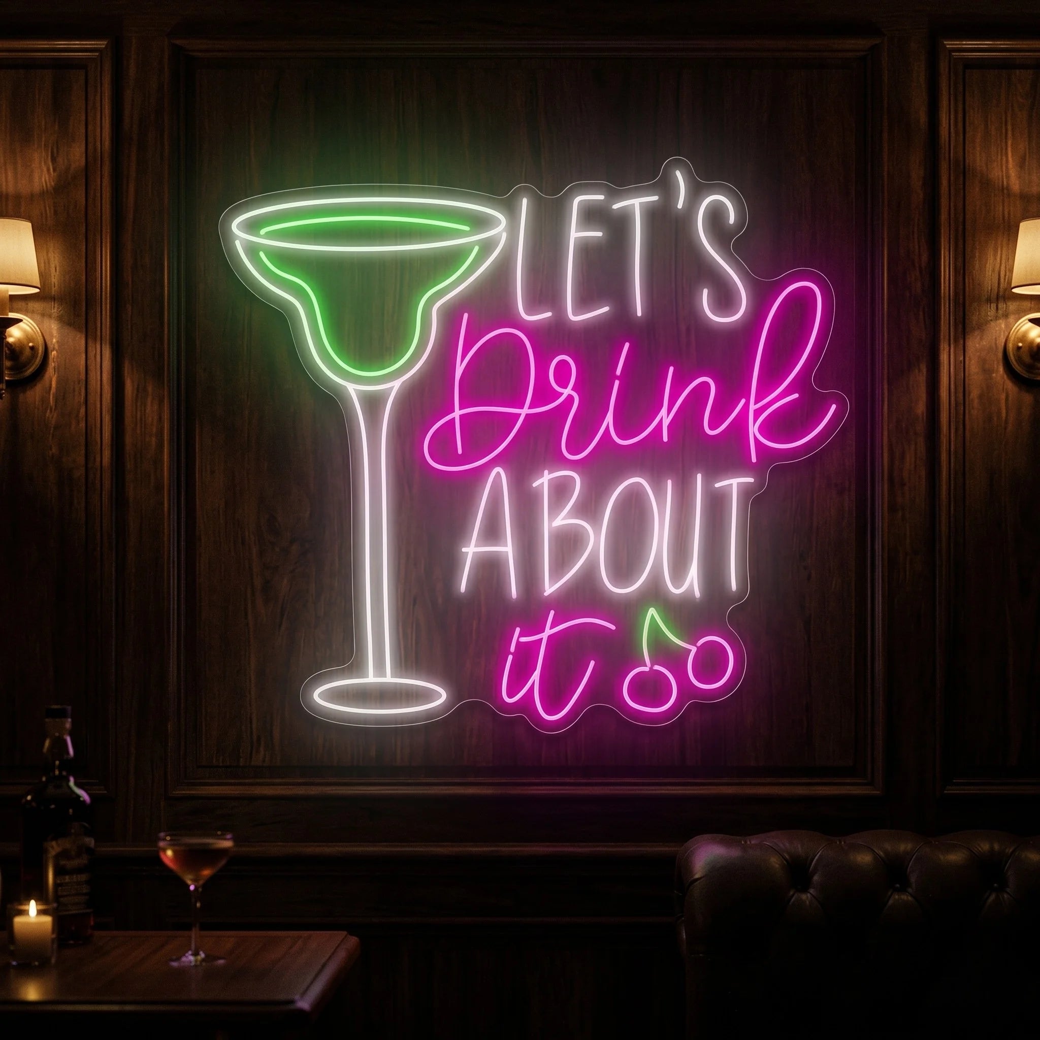Photo of the 'Let's Drink About It' neon sign glowing in multi-color against a styled interior wall.