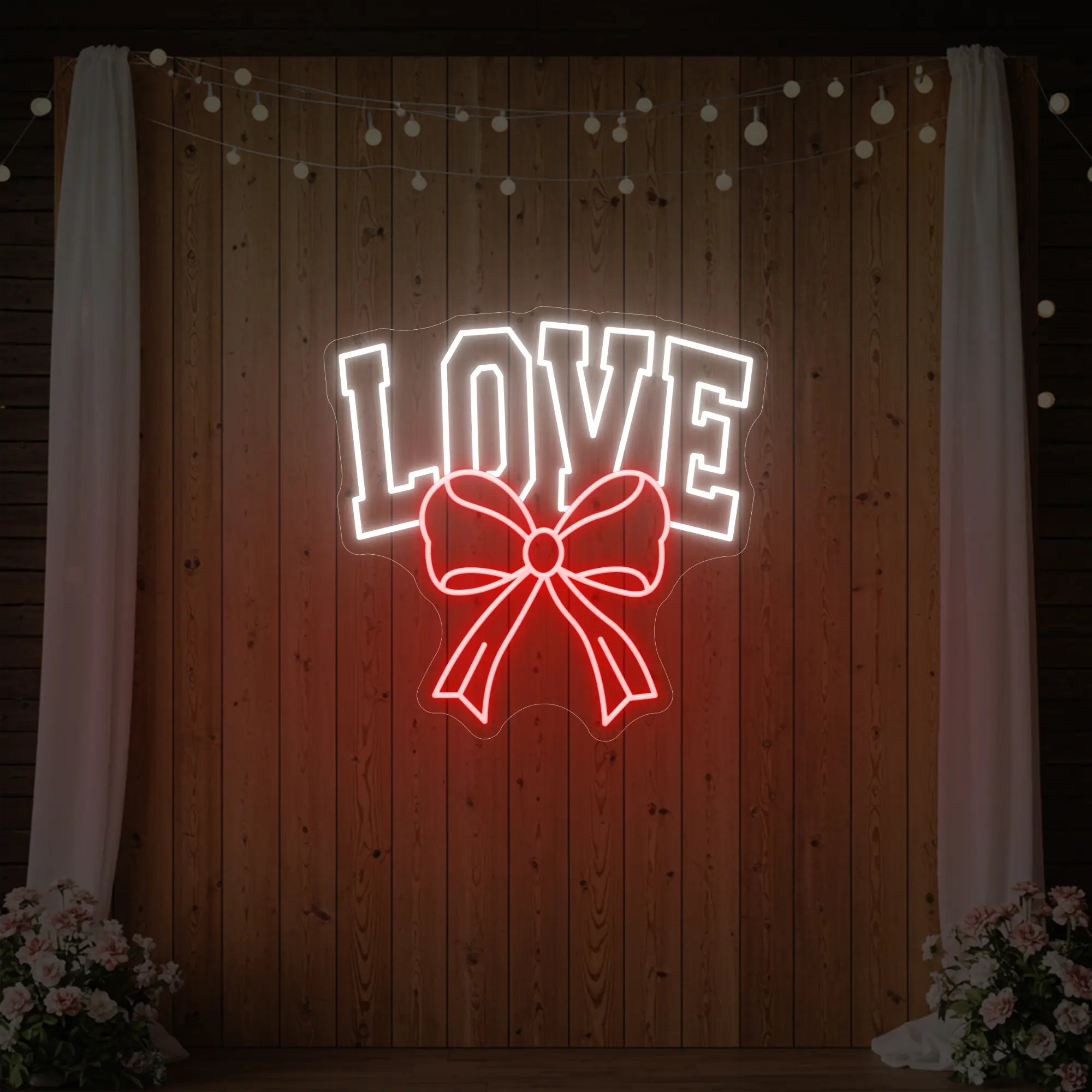 Photo of the 'Love and Ribbon' neon sign glowing in red against a styled interior wall.