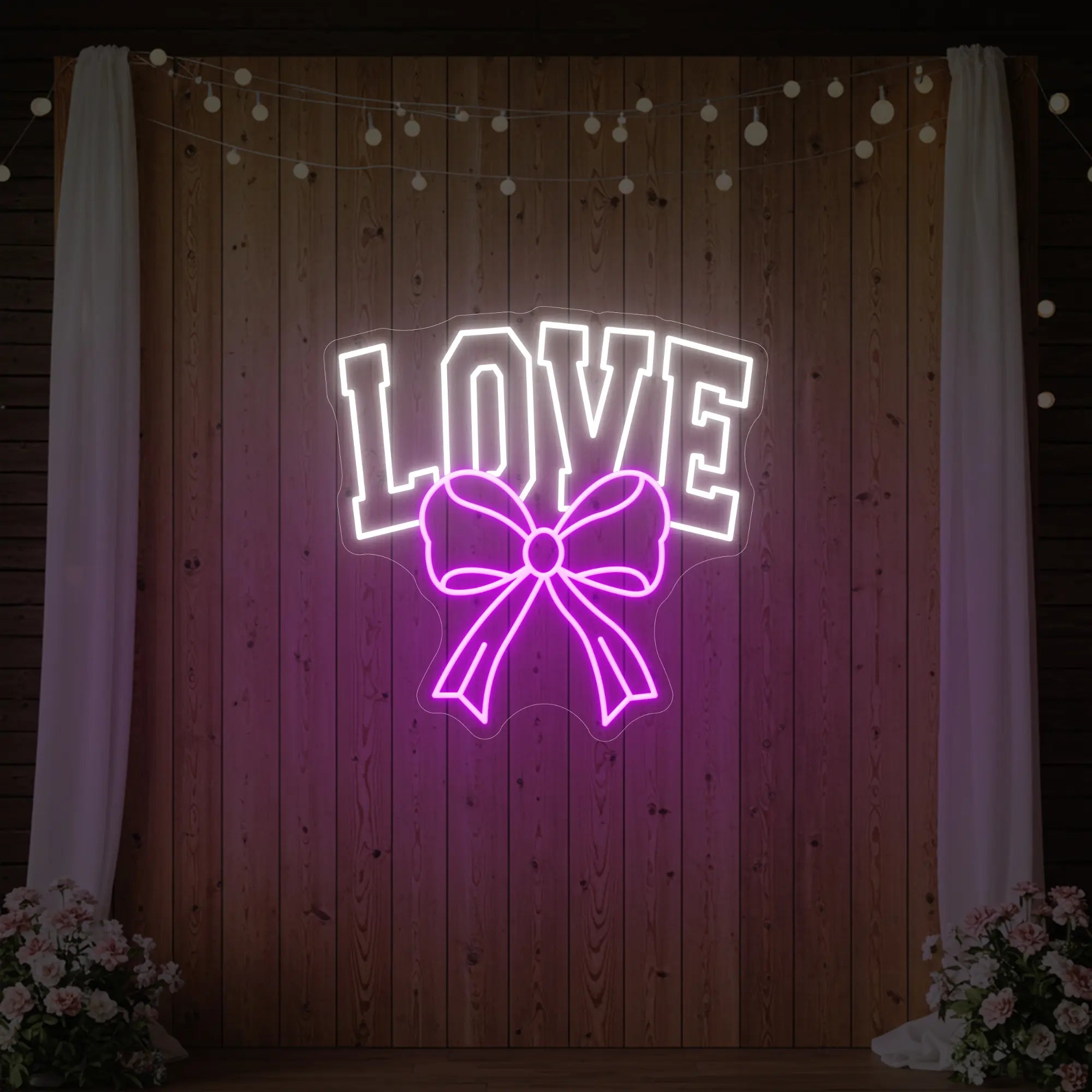 Photo of the 'Love and Ribbon' neon sign glowing in deep pink against a styled interior wall.