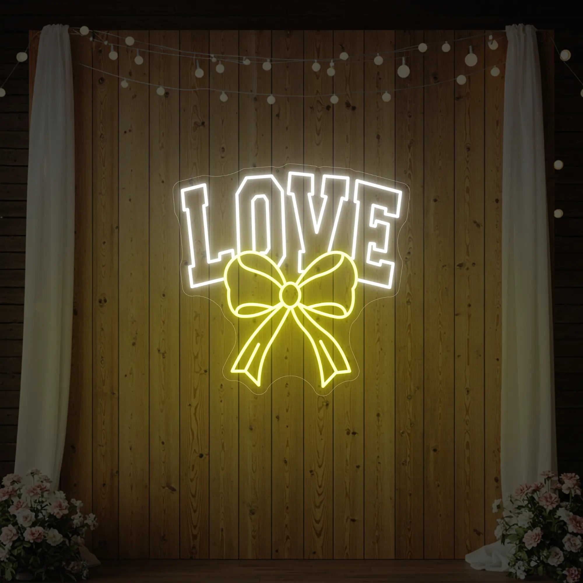 Photo of the 'Love and Ribbon' neon sign glowing in lemon yellow against a styled interior wall.