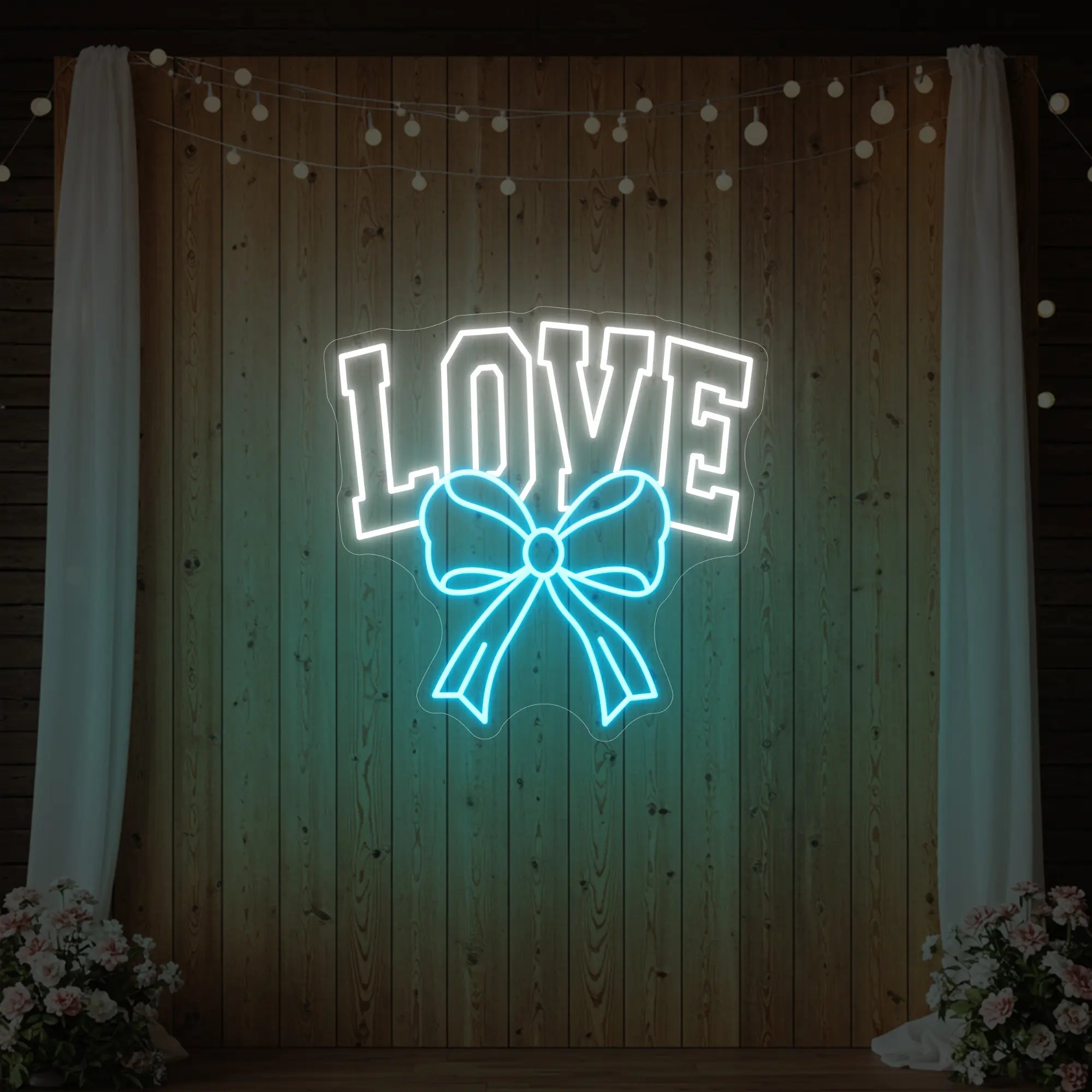 Photo of the 'Love and Ribbon' neon sign glowing in ice blue against a styled interior wall.