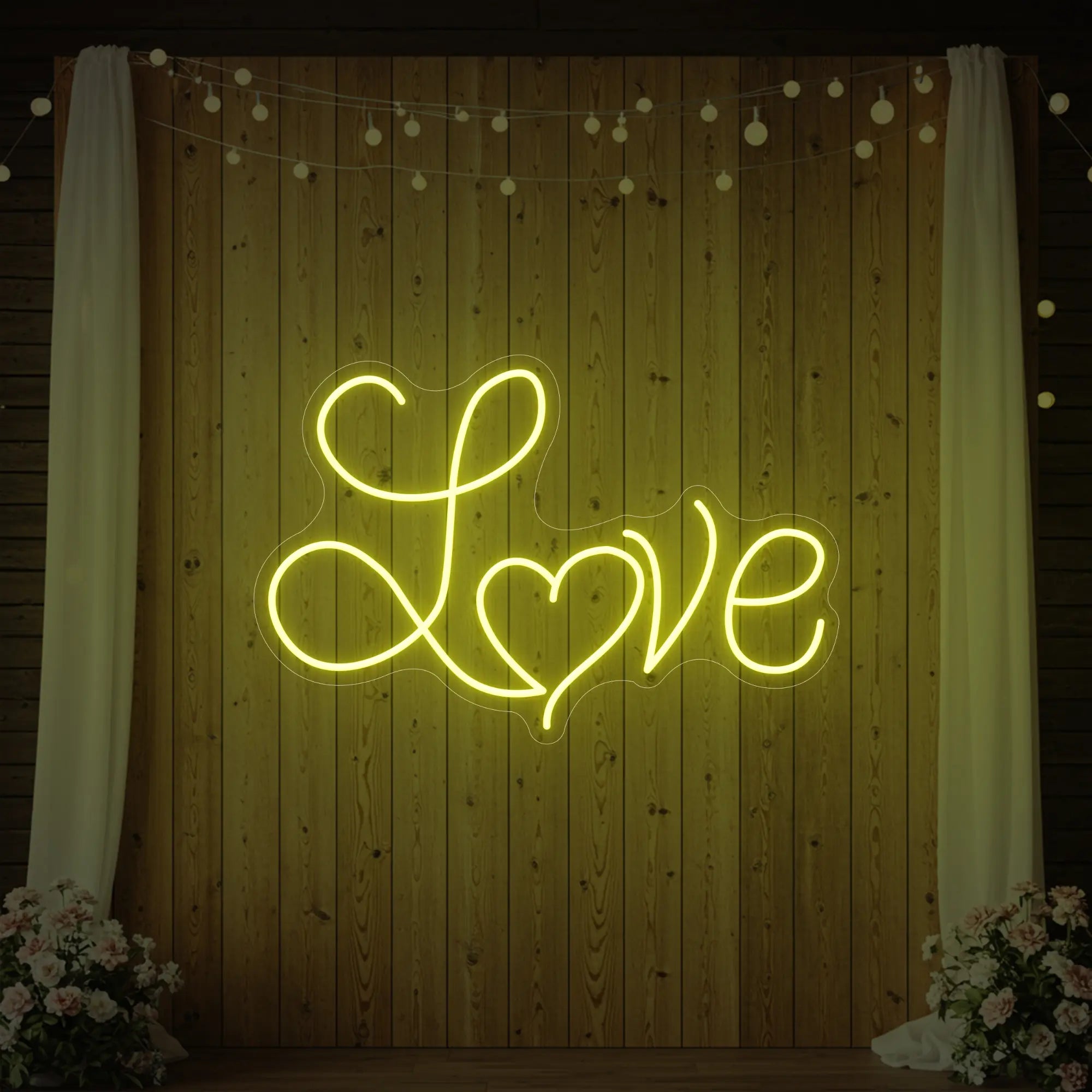 Photo of the 'Love Heart' neon sign glowing in lemon yellow against a styled interior wall.