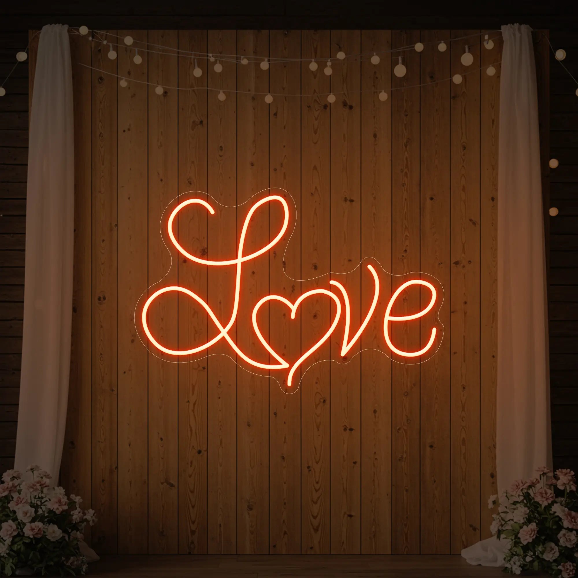 Photo of the 'Love Heart' neon sign glowing in golden yellow against a styled interior wall.