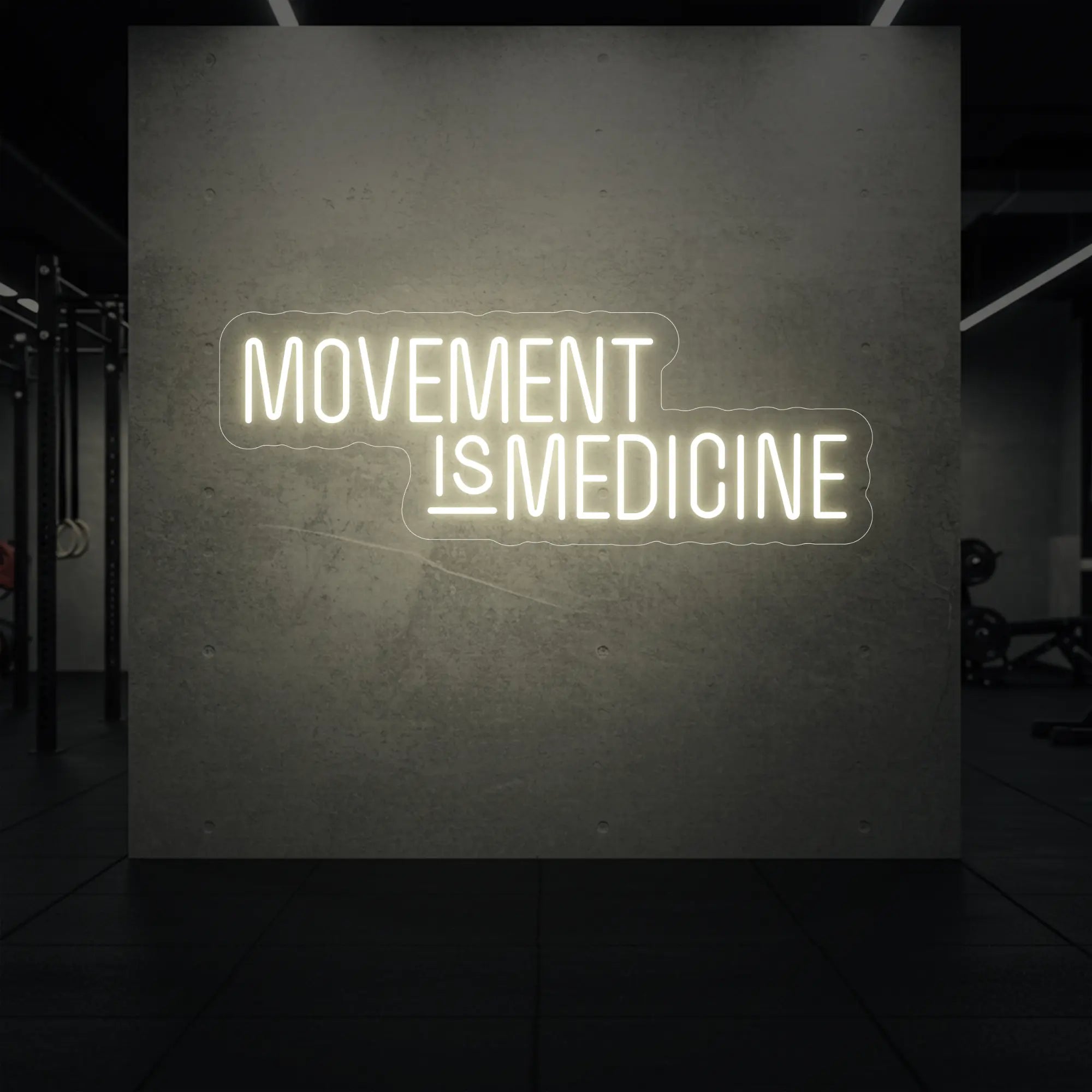 'Movement Is Medicine' neon sign glowing in warm white against a styled interior wall.