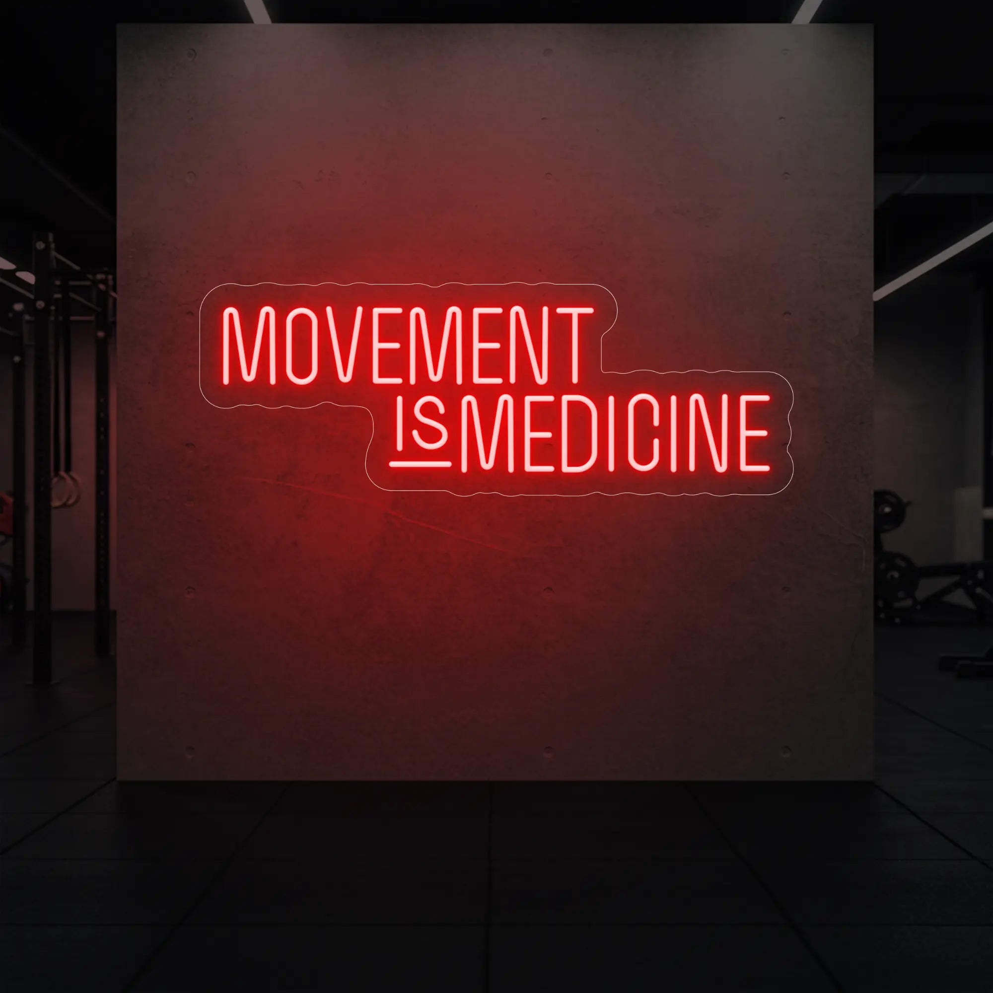 'Movement Is Medicine' neon sign glowing in red against a styled interior wall.