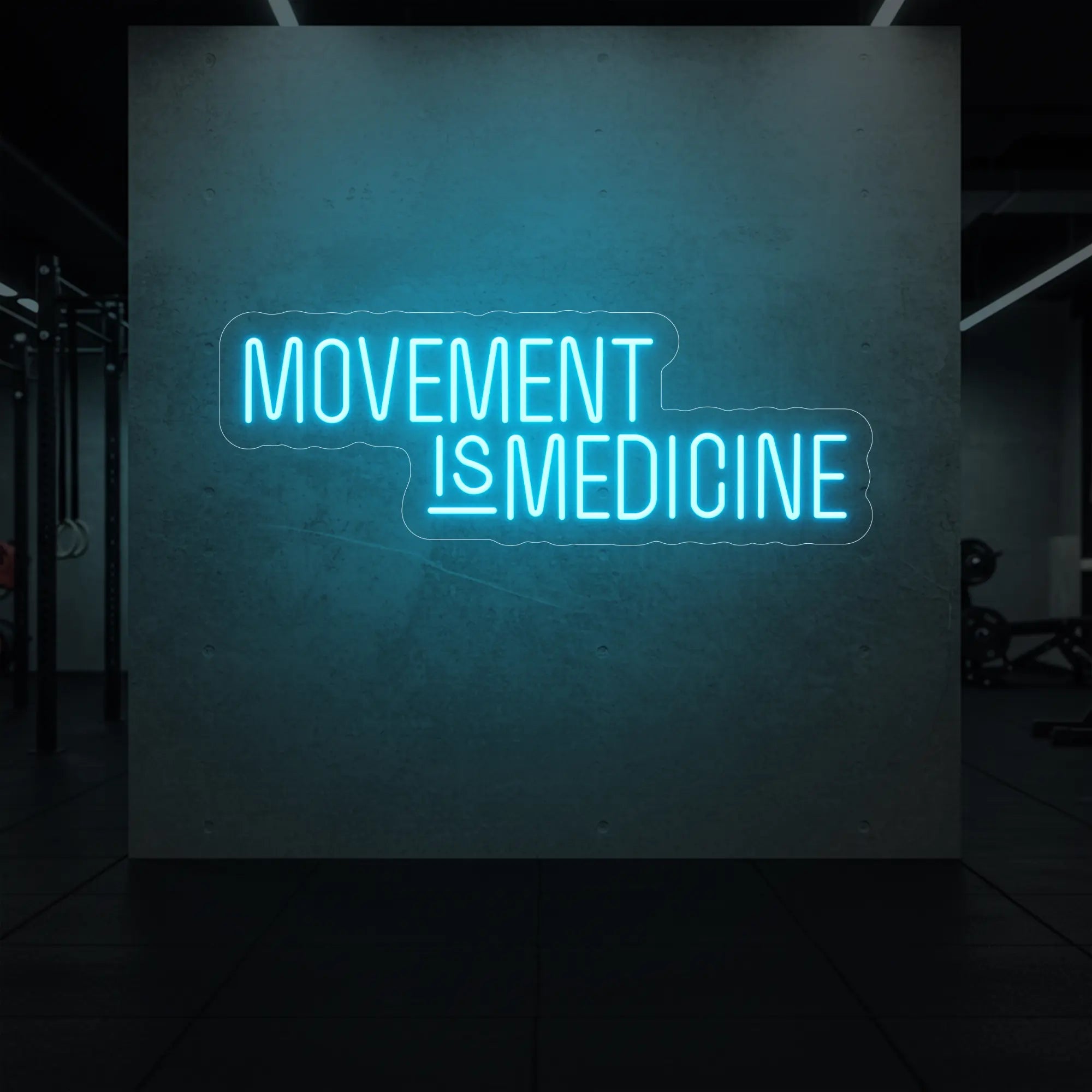 'Movement Is Medicine' neon sign glowing in ice blue against a styled interior wall.