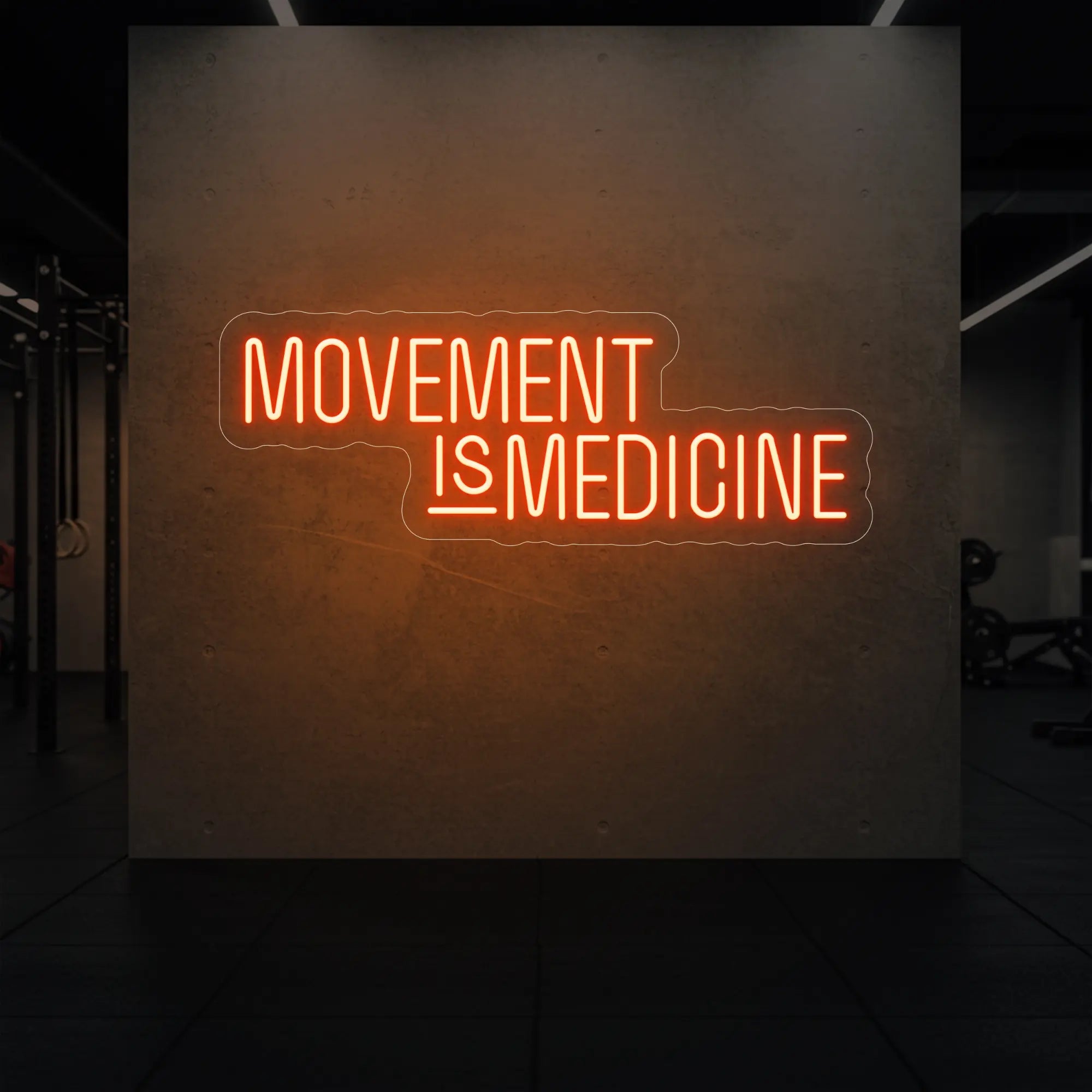'Movement Is Medicine' neon sign glowing in golden yellow against a styled interior wall.