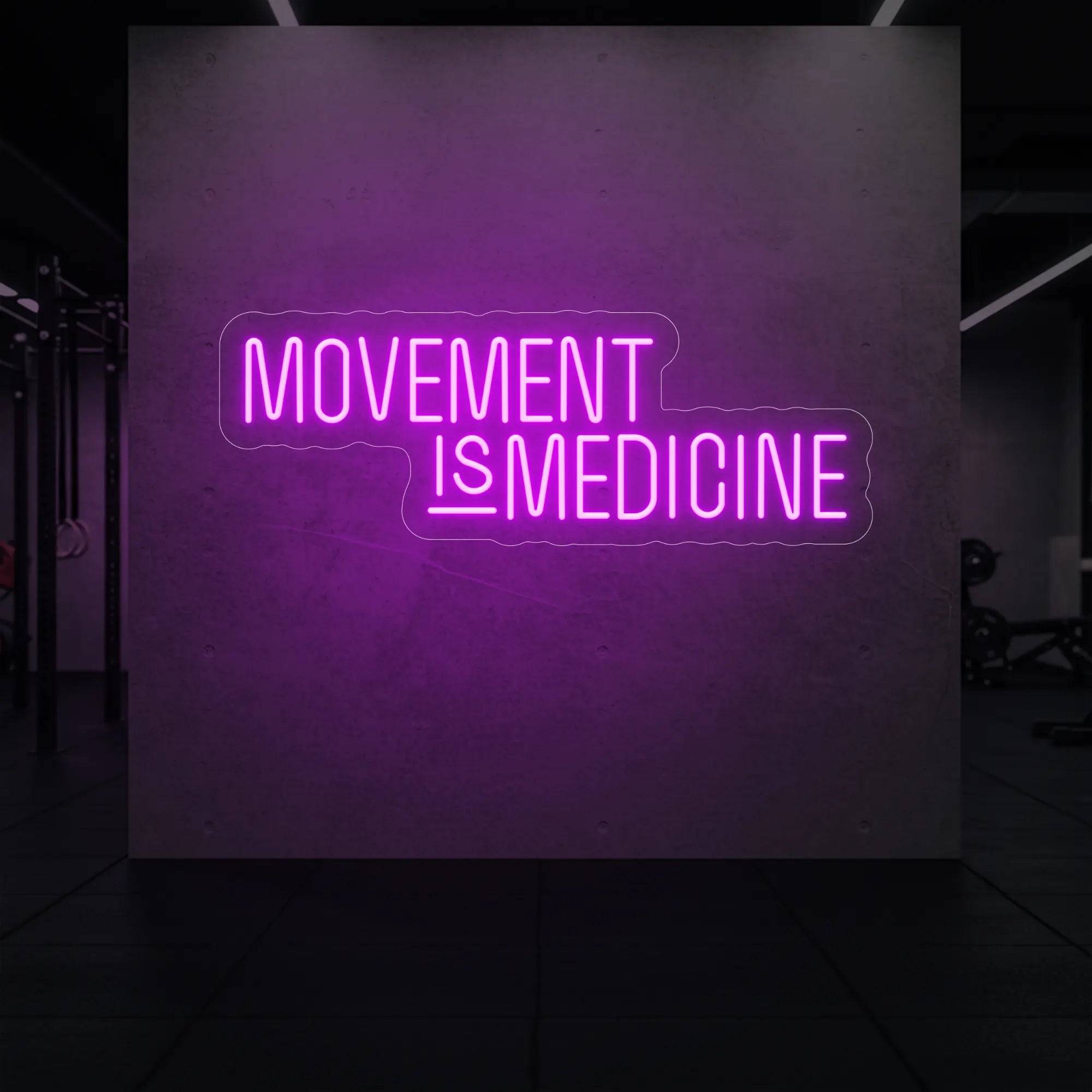 'Movement Is Medicine' neon sign glowing in deep pink against a styled interior wall.
