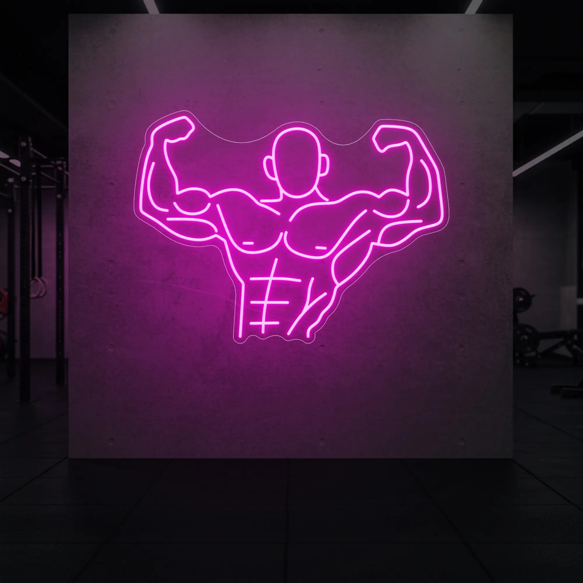 'Muscle Man (Torso-Up Flex)' neon sign glowing in light pink against a styled interior wall.