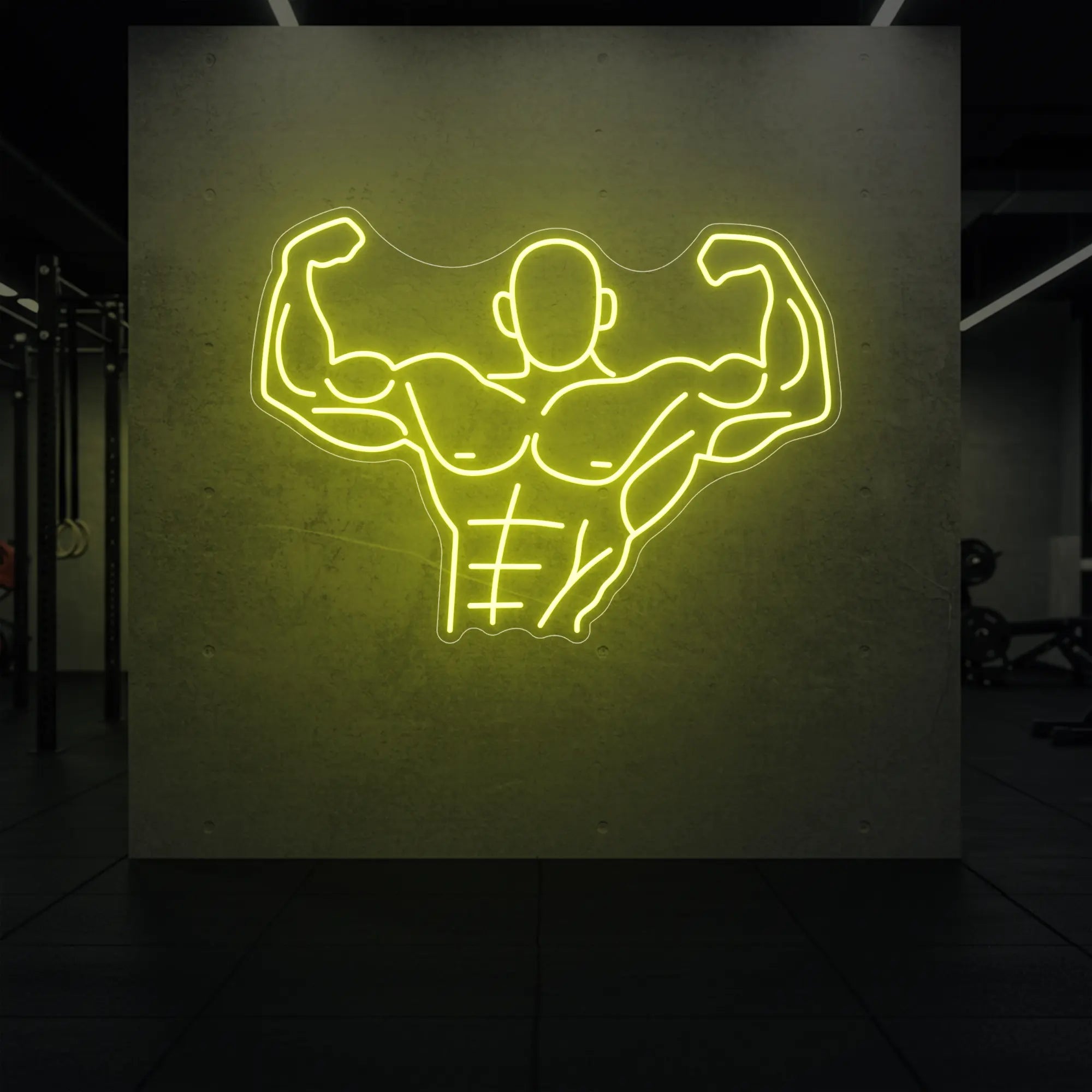 'Muscle Man (Torso-Up Flex)' neon sign glowing in lemon yellow against a styled interior wall.
