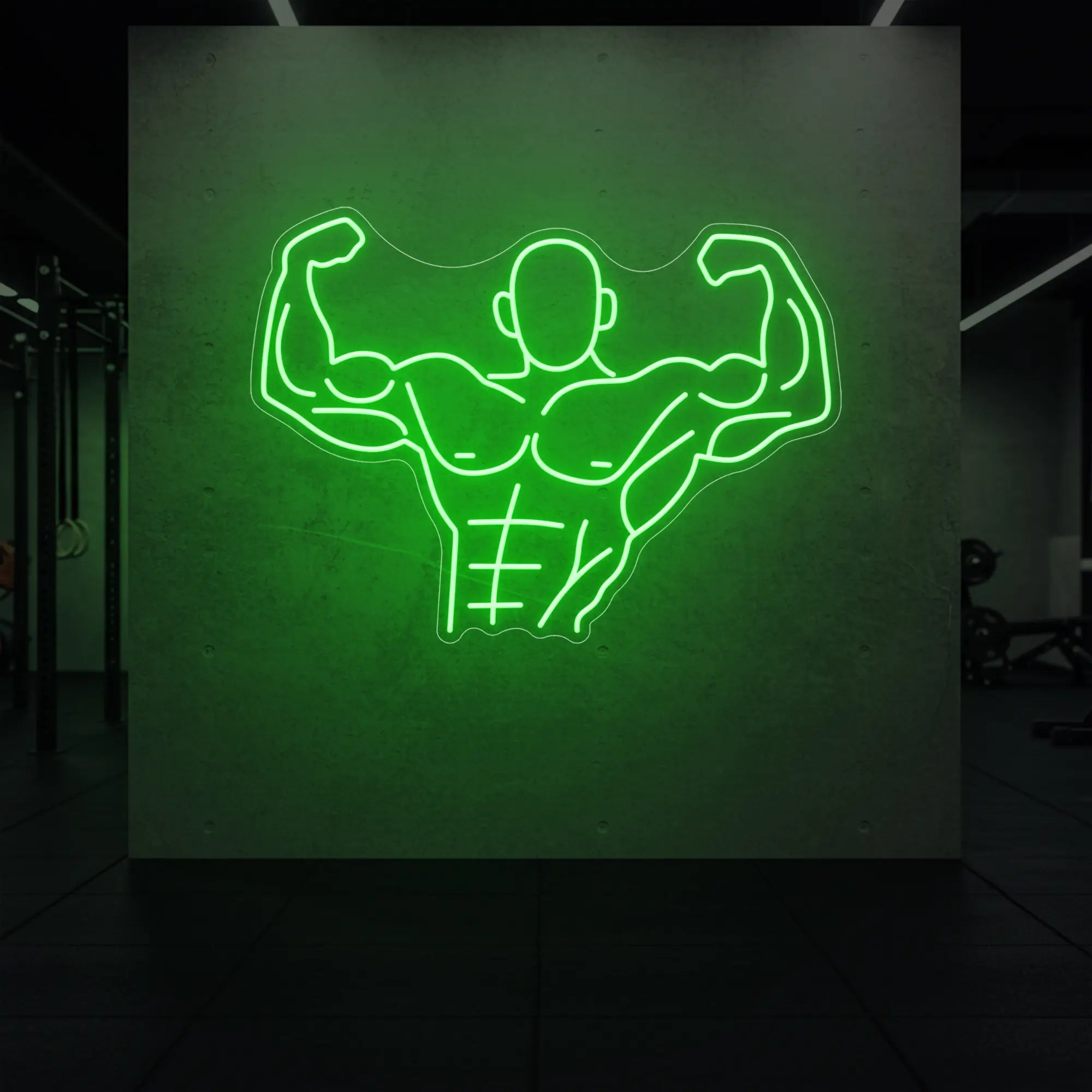 'Muscle Man (Torso-Up Flex)' neon sign glowing in green against a styled interior wall.