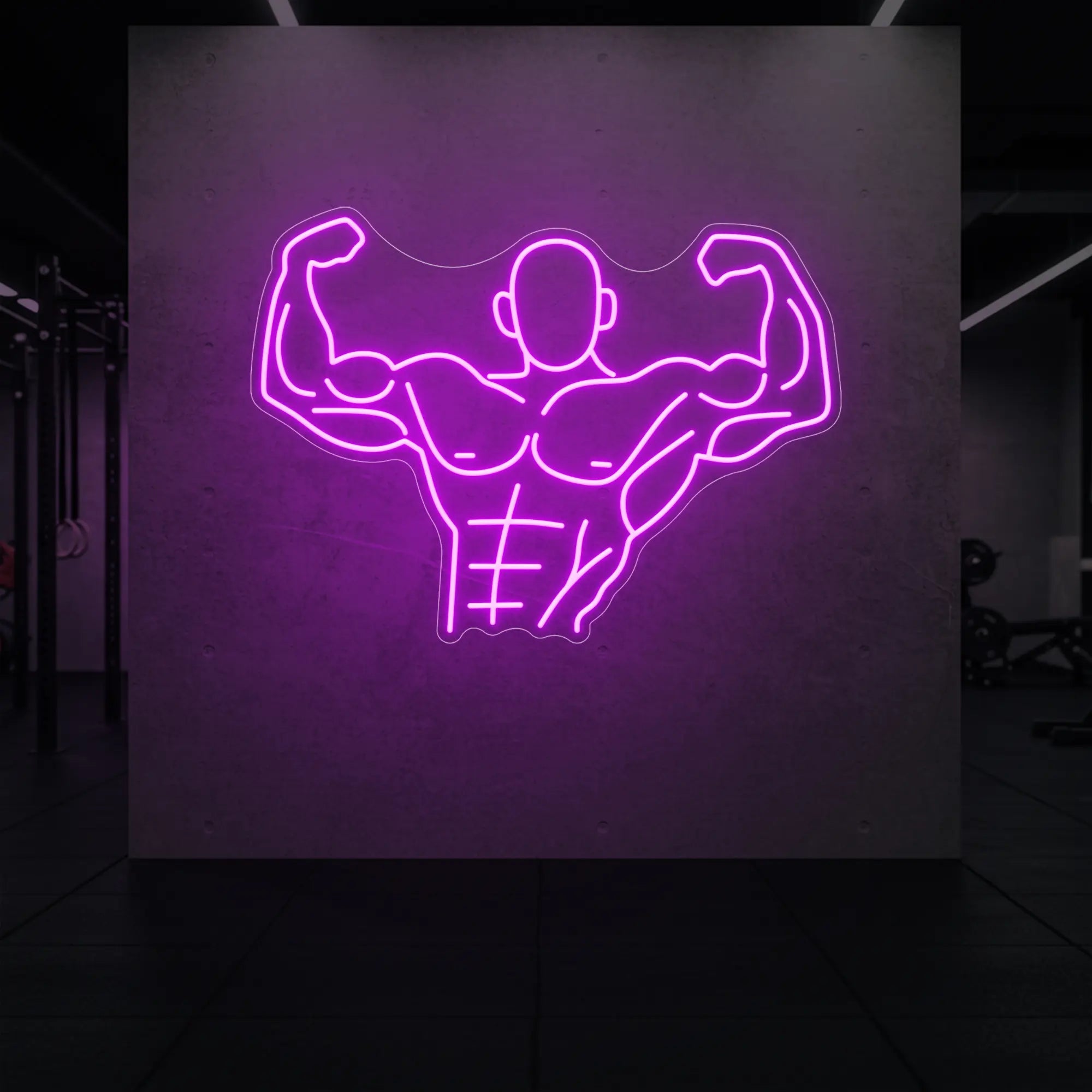 'Muscle Man (Torso-Up Flex)' neon sign glowing in deep pink against a styled interior wall.