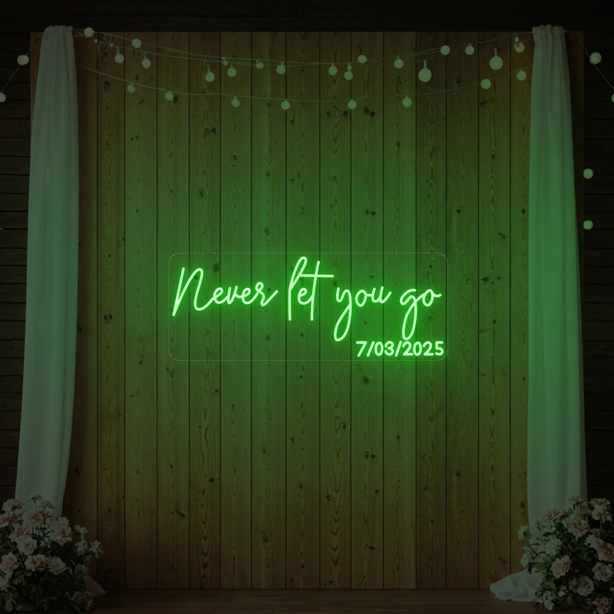 'Never Let You Go' neon sign glowing in green against a styled interior wall.