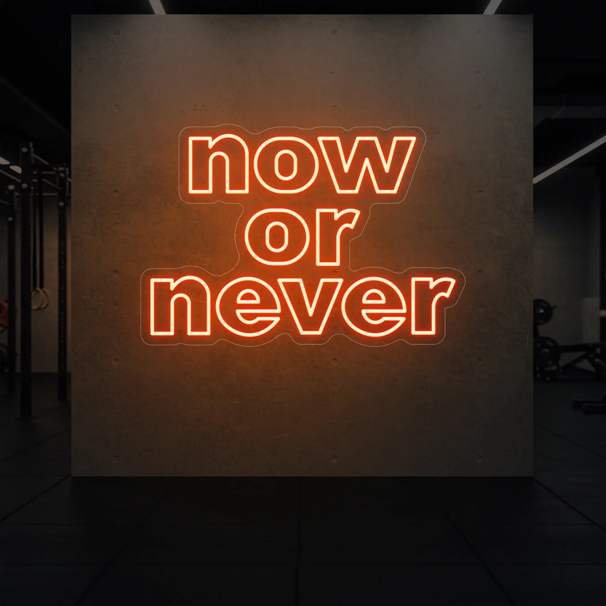 'Now or Never' neon sign glowing in golden yellow against a styled interior wall.