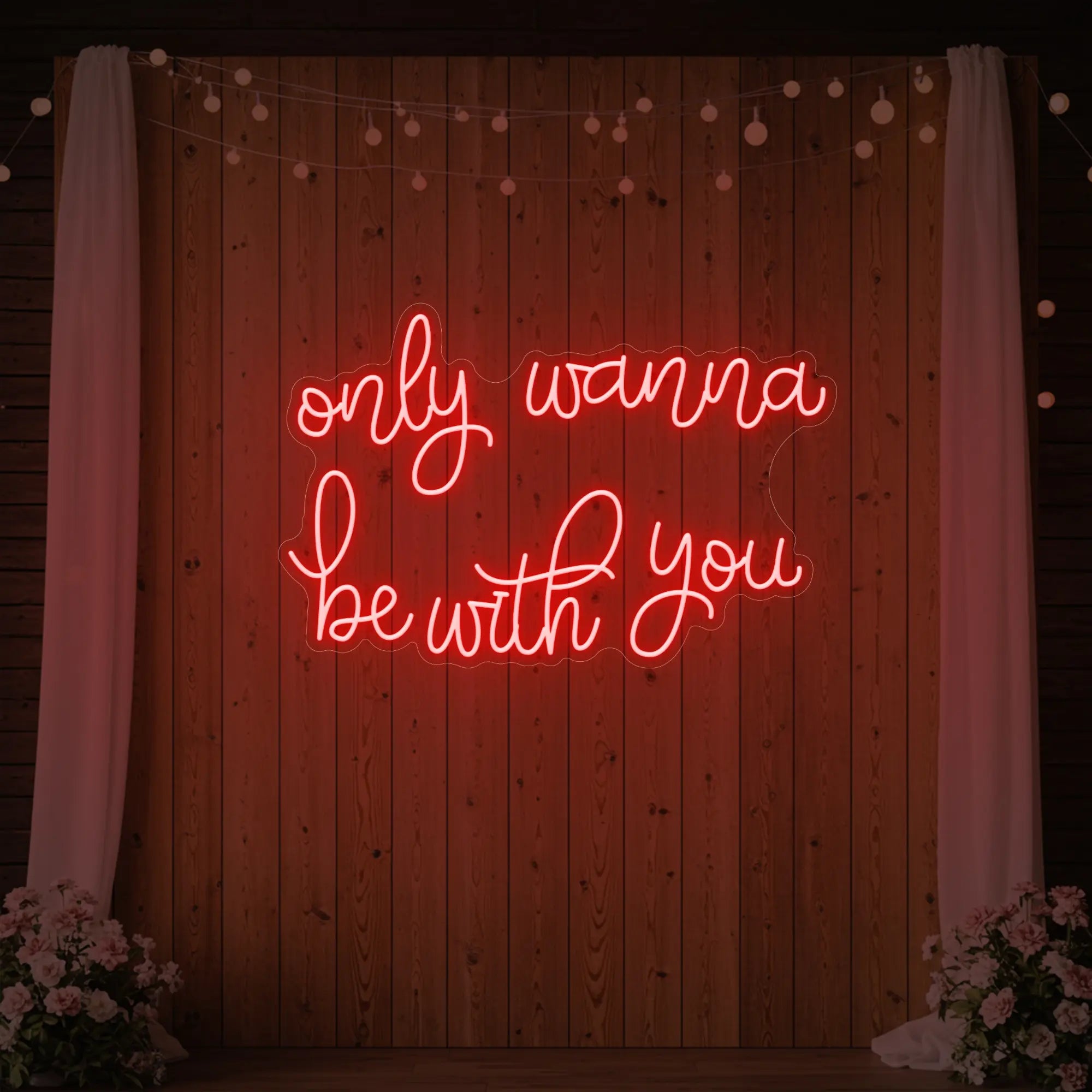 Photo of the 'Only Wanna Be With You' neon sign glowing in red against a styled interior wall.