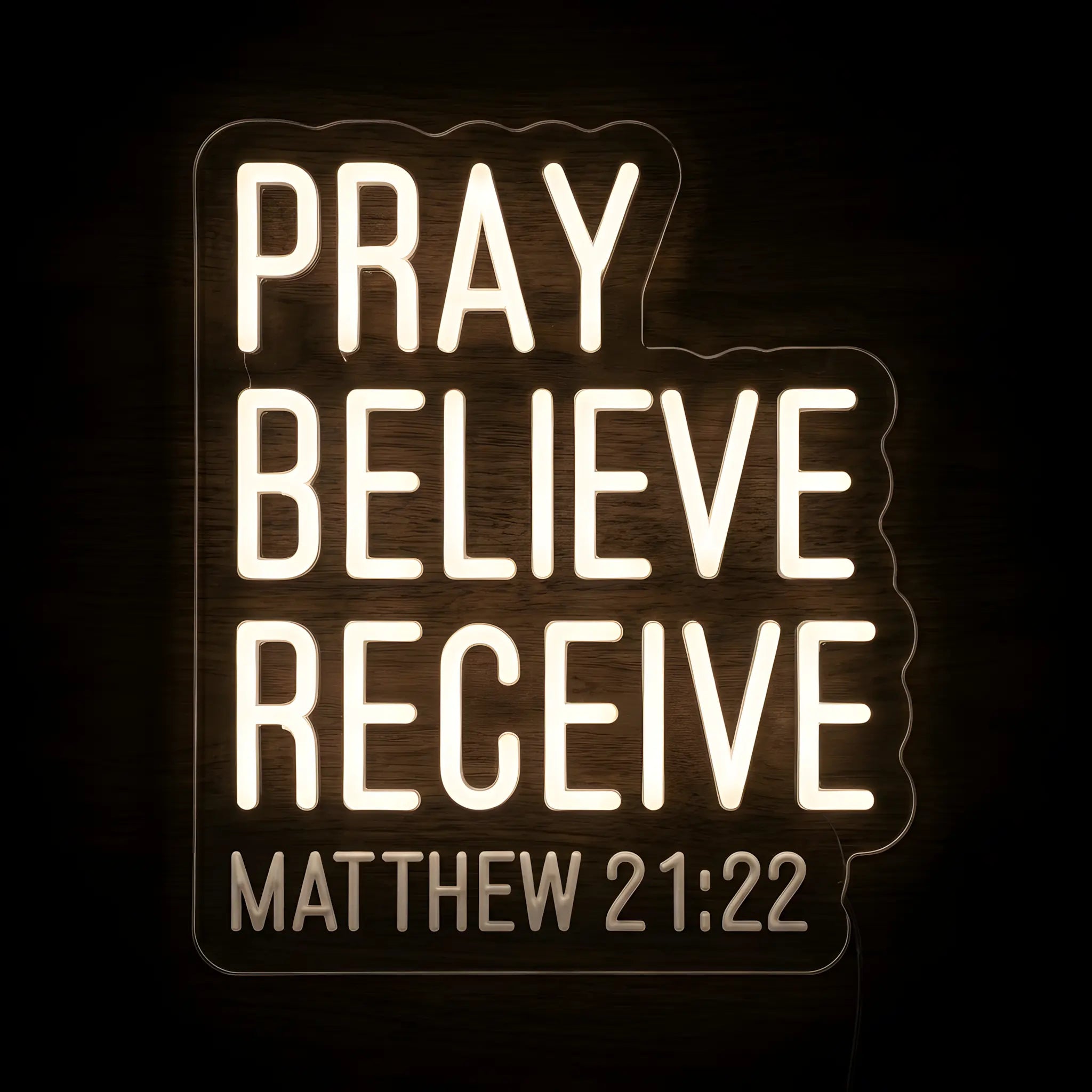Pray Believe Receive LED neon sign featuring Matthew 21:22 in warm white illumination on a precision-cut clear acrylic backing for Christian wall decor.