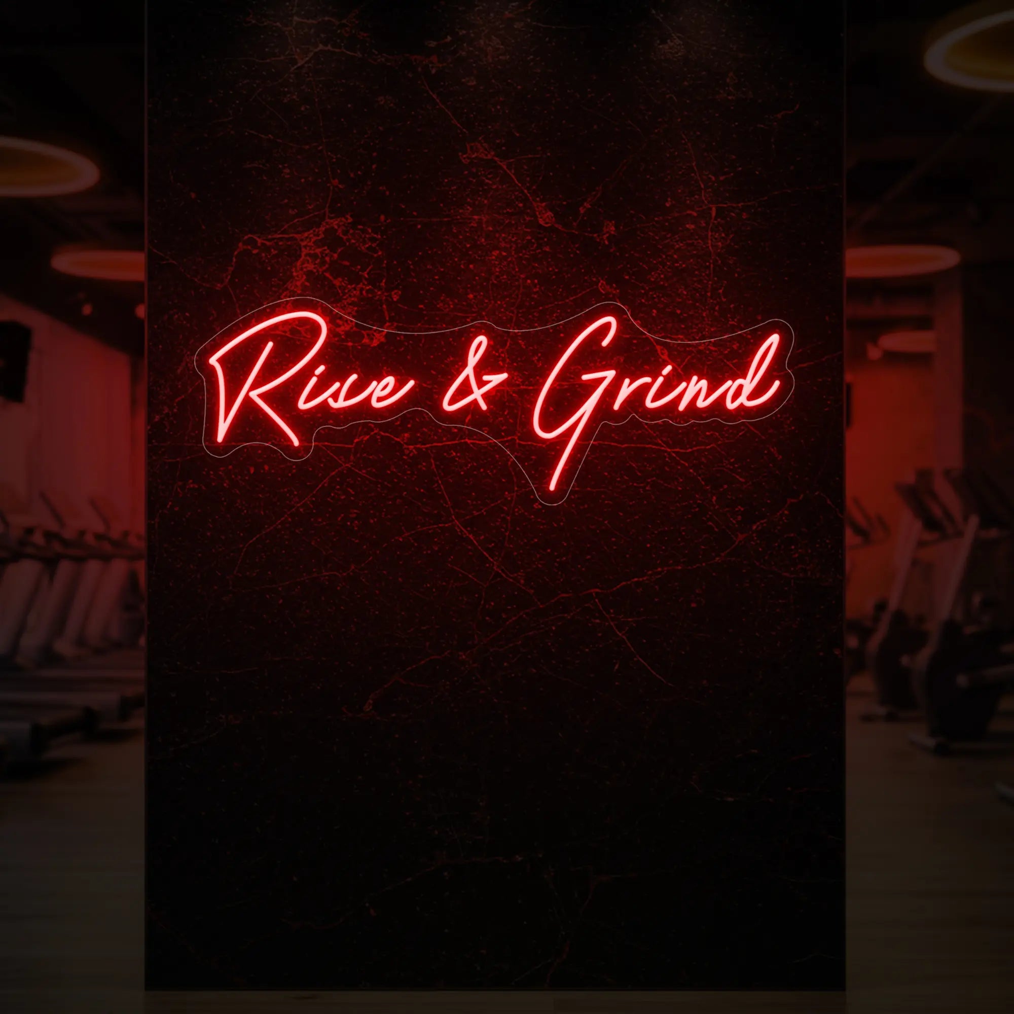 'Rise & Grind' neon sign glowing in red against a styled interior wall.