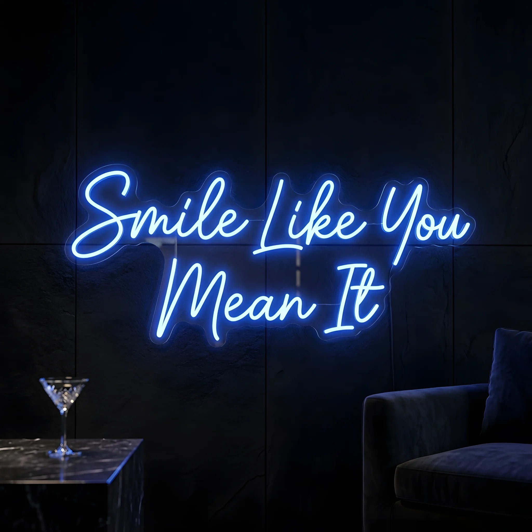 Photo of the 'Smile Like You Mean It' neon sign glowing in blue against a cozy modern interior wall.